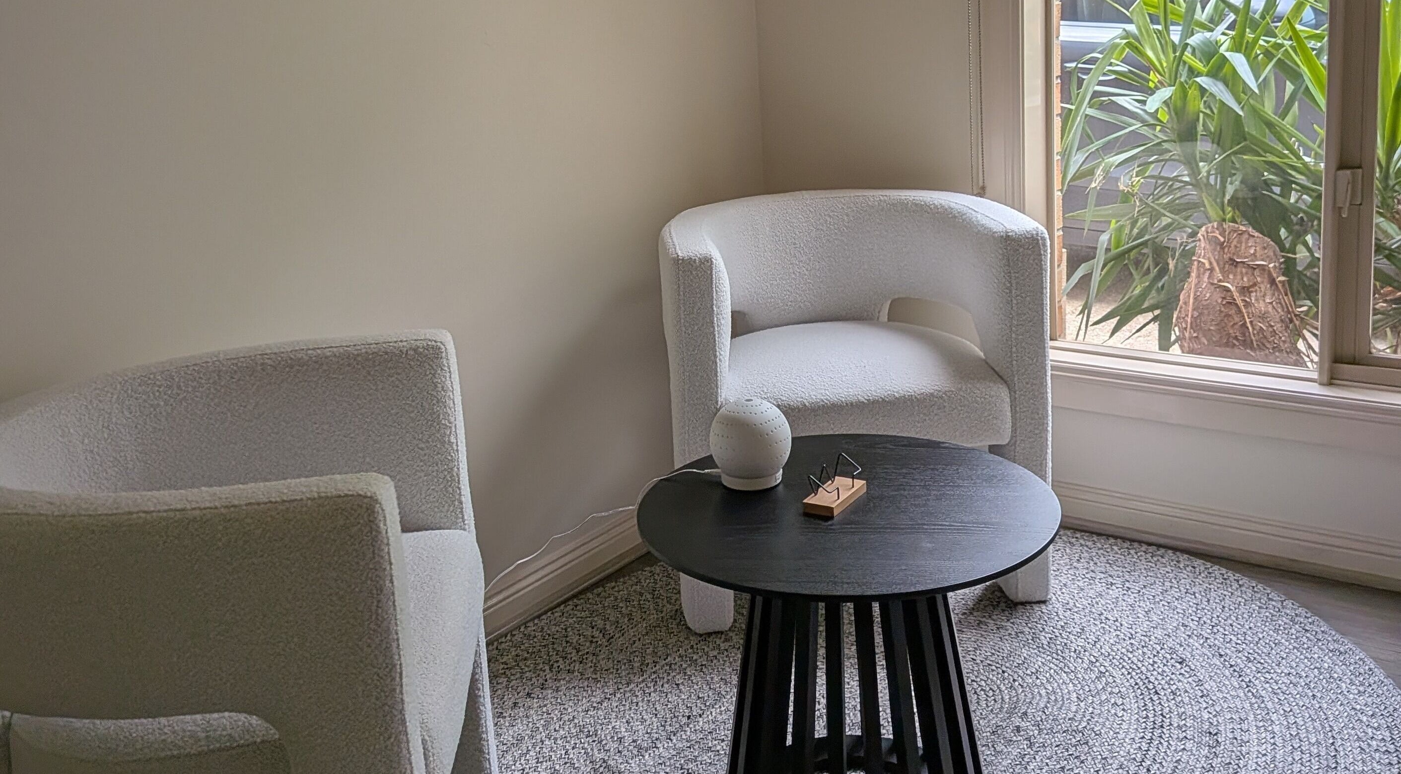 Cozy seating area at Lume Skin Aesthetics in Diamond Creek, Victoria, AU, with plush chairs and natural light.