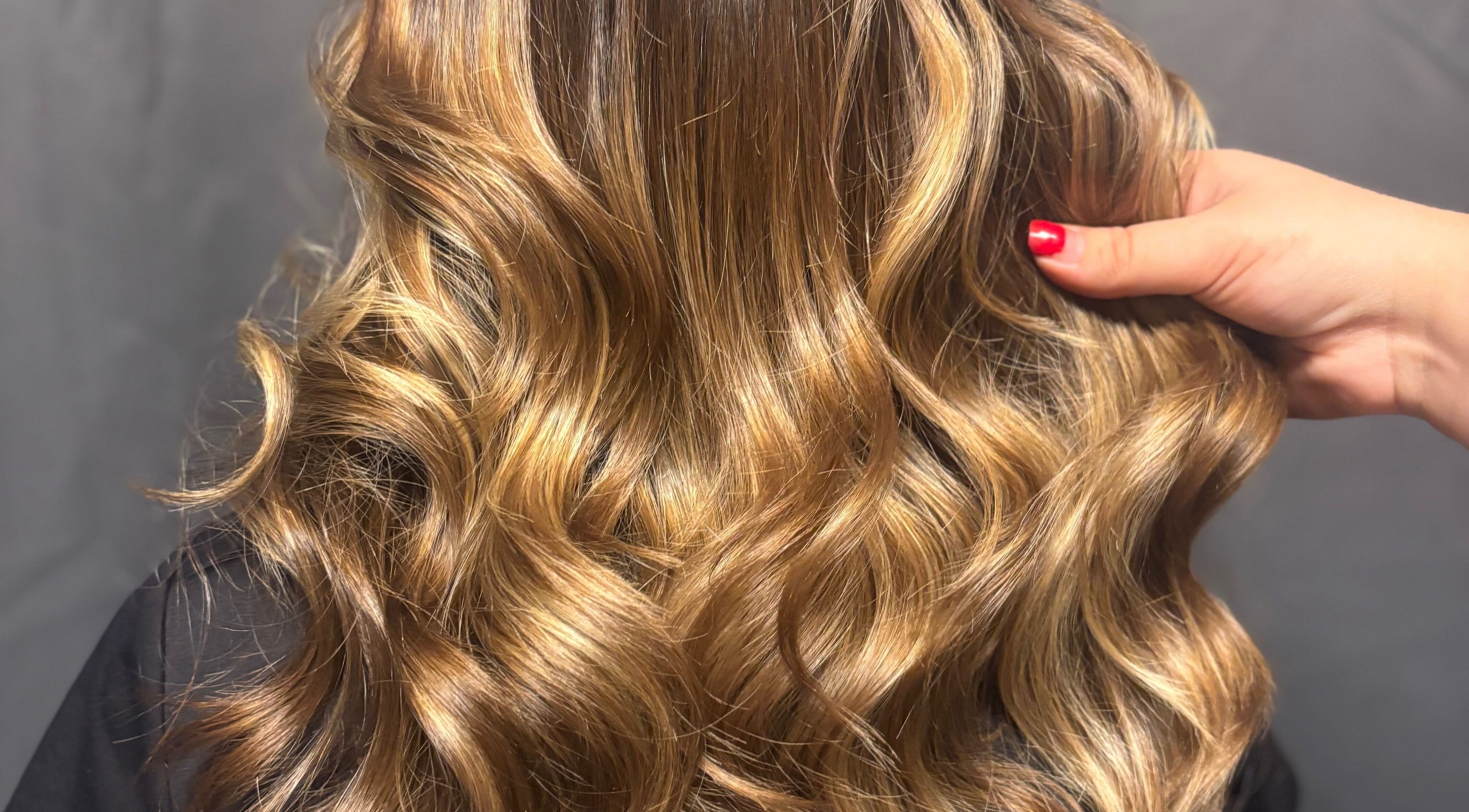 Close-up of styled golden curls at Hairbylauren in Dereham, England, GB.