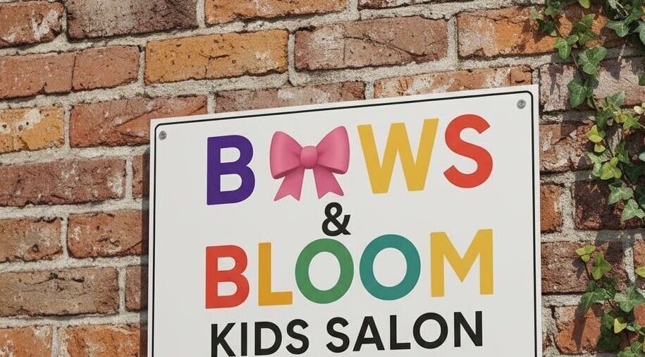 Sign for B🎀ws & Bloom kids Salon, Cape Town. Bright letters on brick wall highlight the cheerful venue.