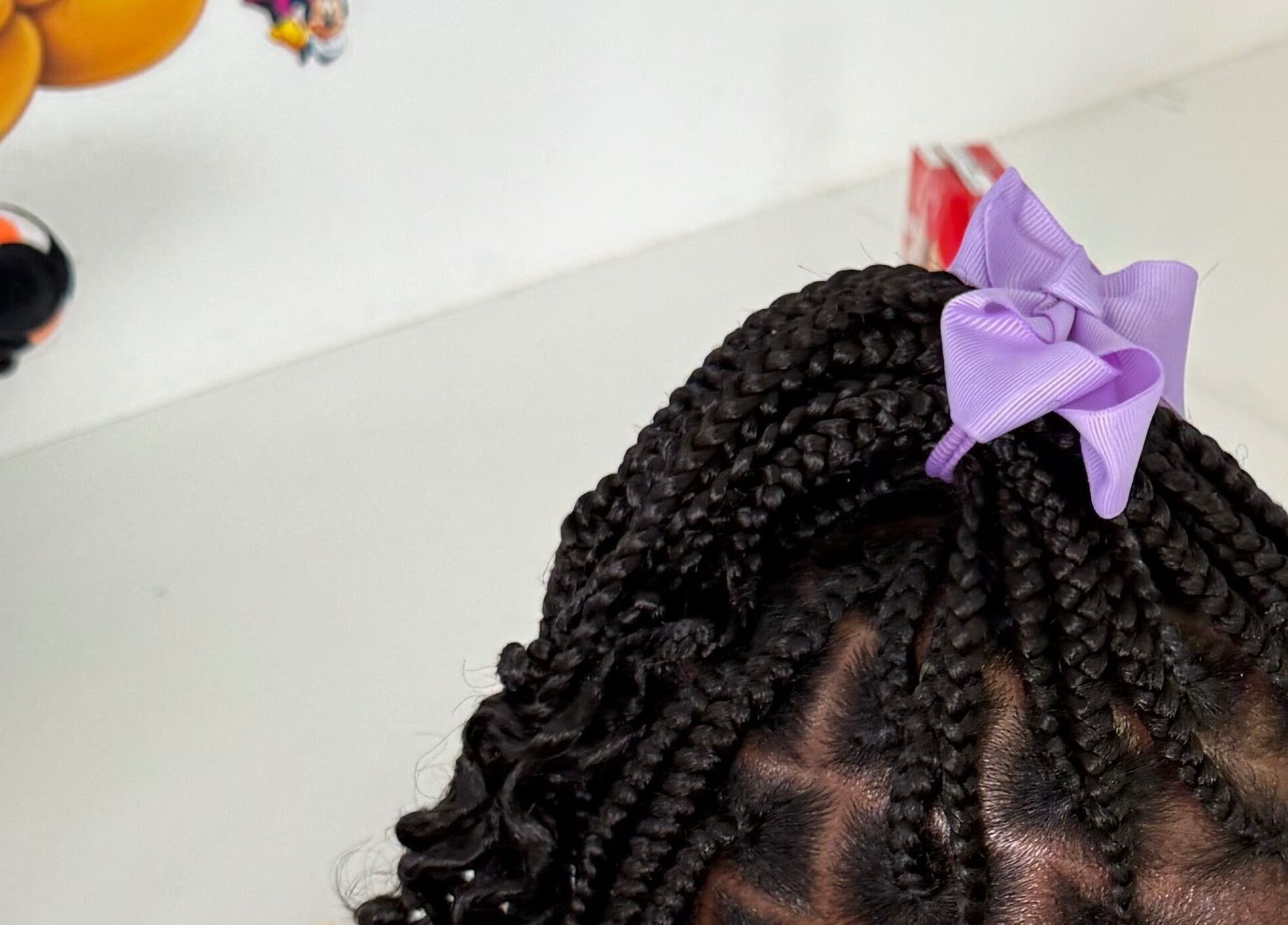 Stylish braids with a purple bow at B🎀ws & Bloom kids Salon, Cape Town, Western Cape, ZA.