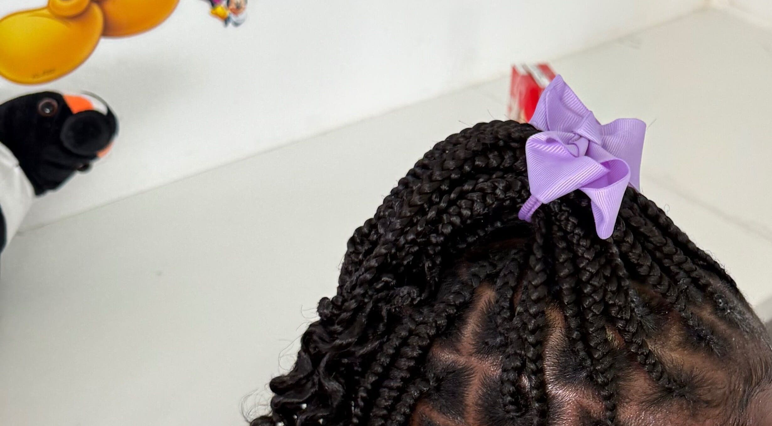 Stylish braids with a purple bow at B🎀ws & Bloom kids Salon, Cape Town, Western Cape, ZA.