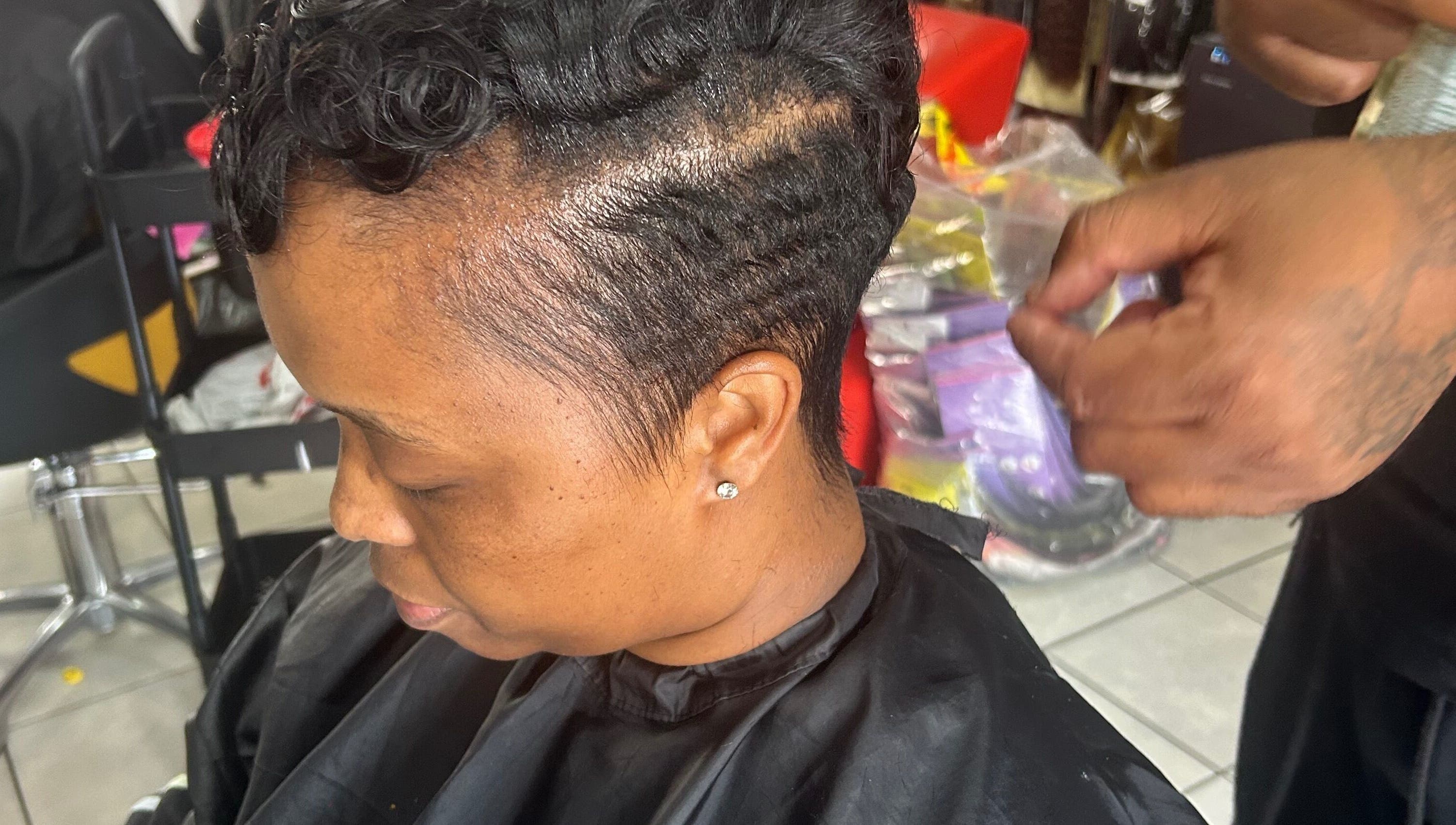 Professional hairstylist crafting elegant short curls at Goodness Glamour, Johannesburg, Gauteng, ZA.
