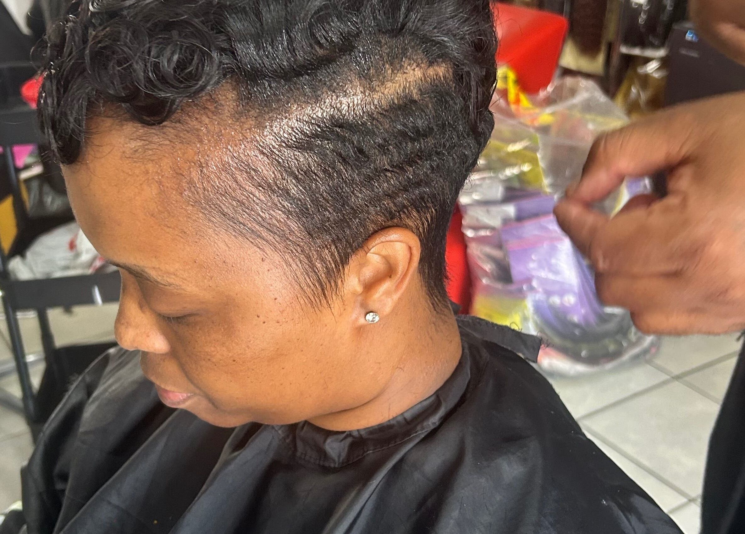 Professional hairstylist crafting elegant short curls at Goodness Glamour, Johannesburg, Gauteng, ZA.