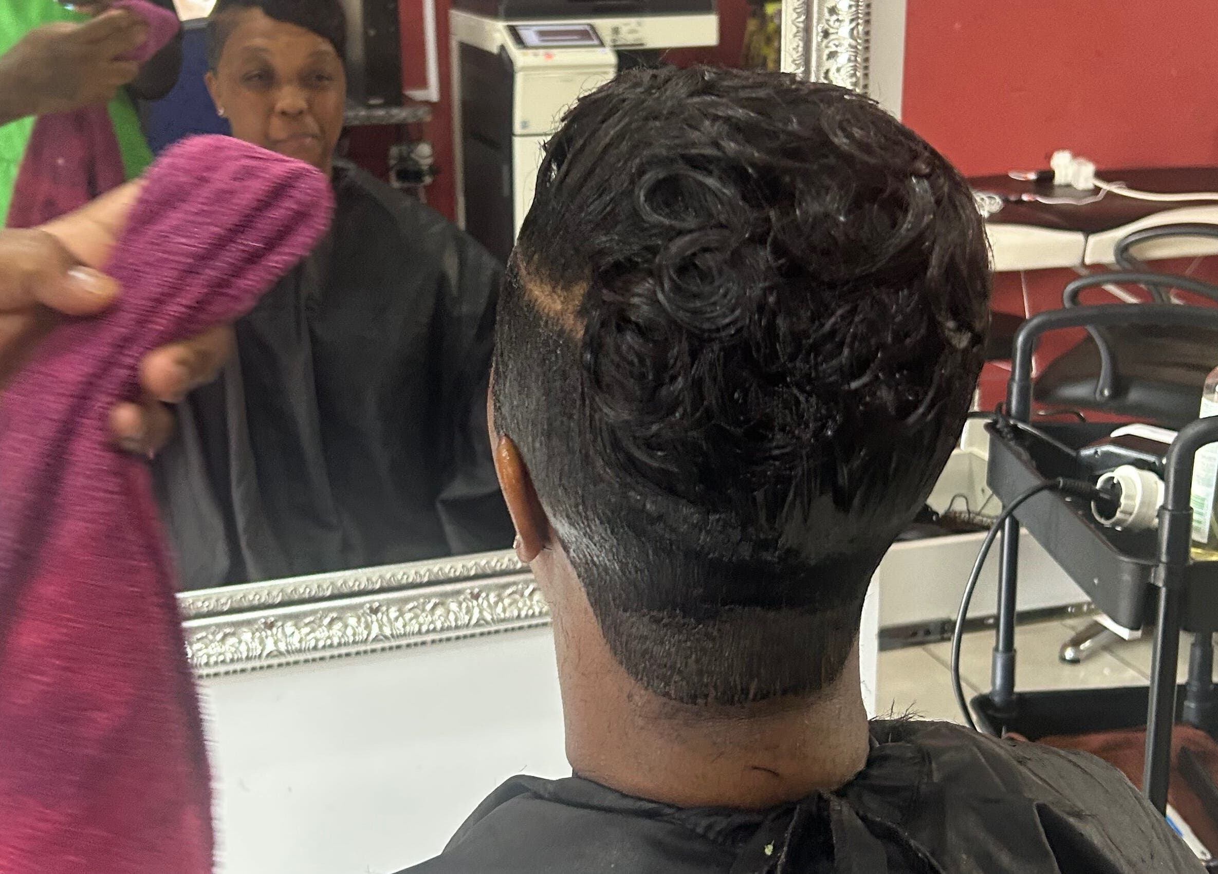 Client enjoying a fresh haircut at Goodness Glamour, Johannesburg, Gauteng, ZA.