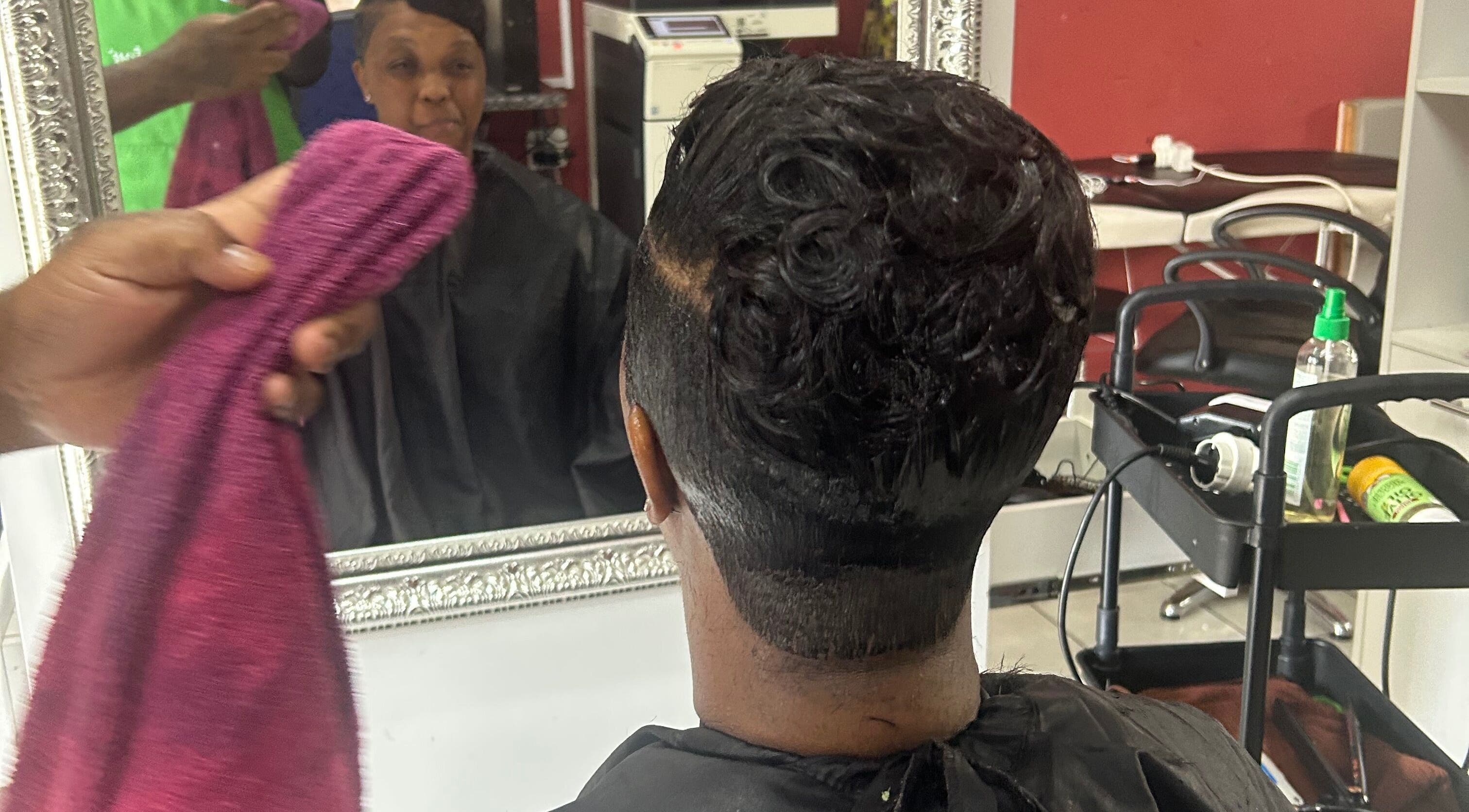 Client enjoying a fresh haircut at Goodness Glamour, Johannesburg, Gauteng, ZA.