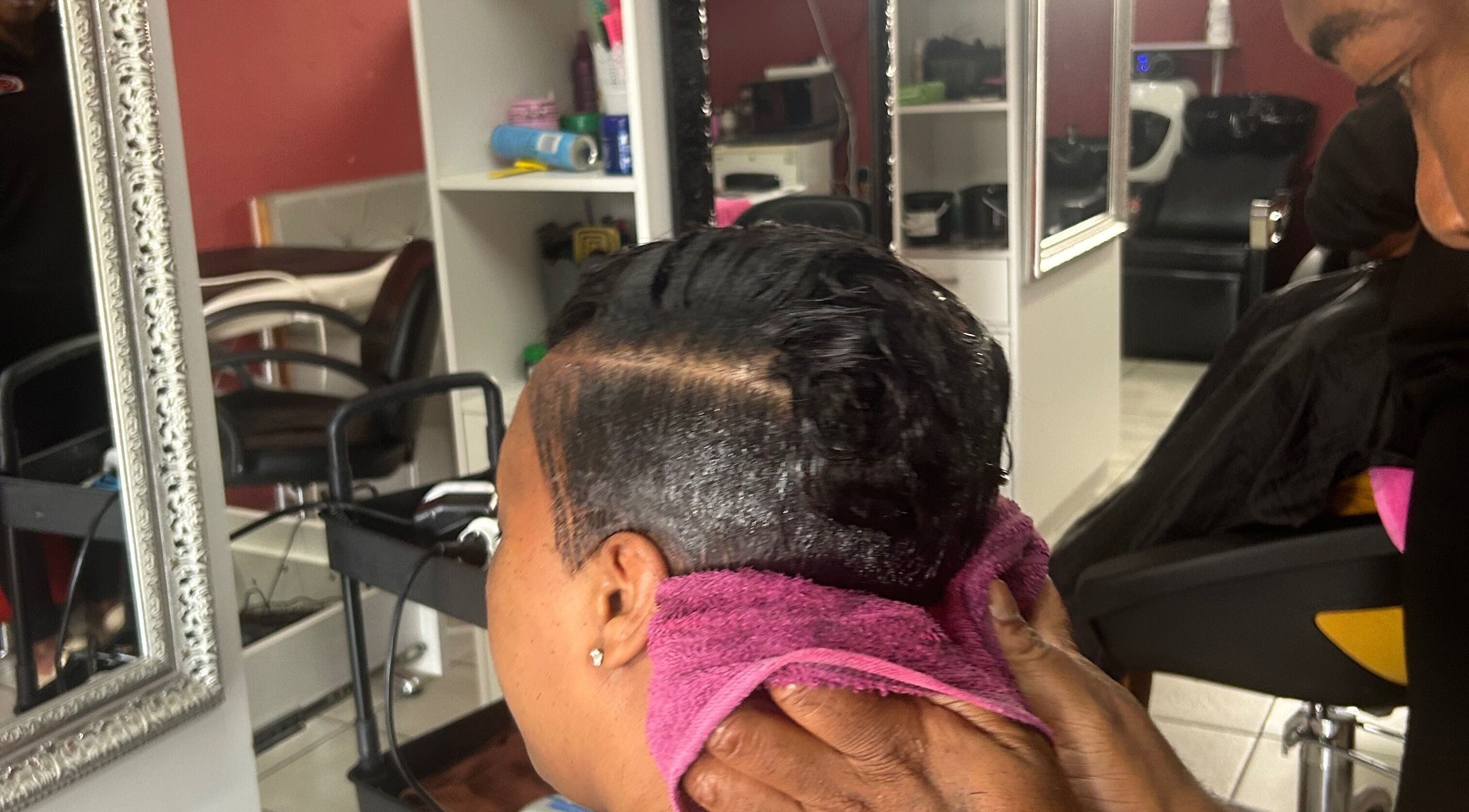Hair treatment at Goodness Glamour in Johannesburg, Gauteng, ZA with stylist using a towel.