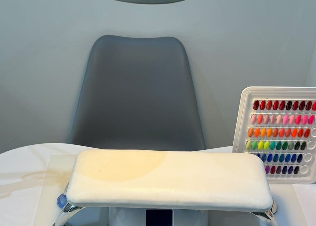 Nail color selection at Nails by T in Harlow, England, GB with a cozy chair and table.