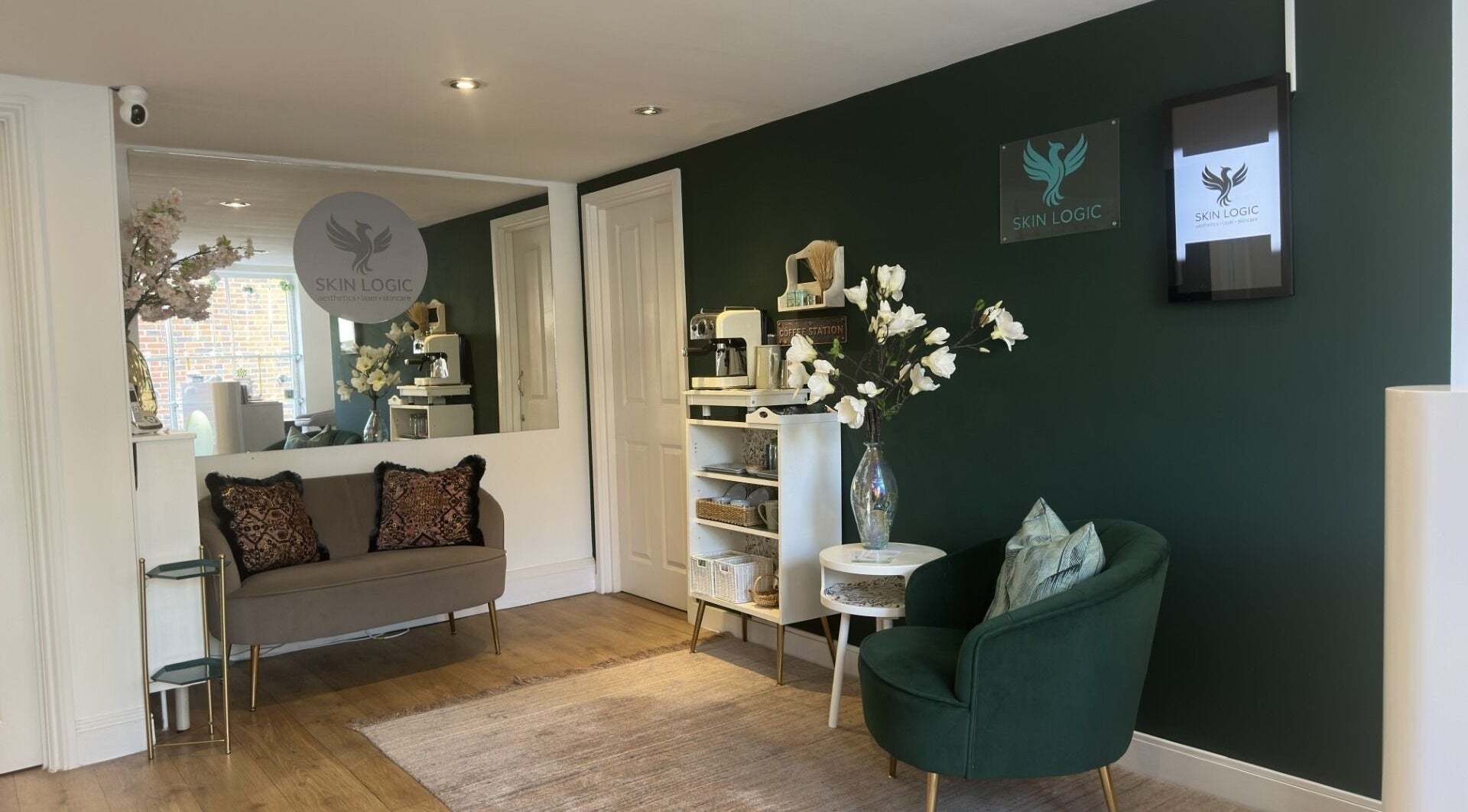 Inviting lobby of Skin Logic in Romsey, England, GB featuring elegant seating and floral decor.