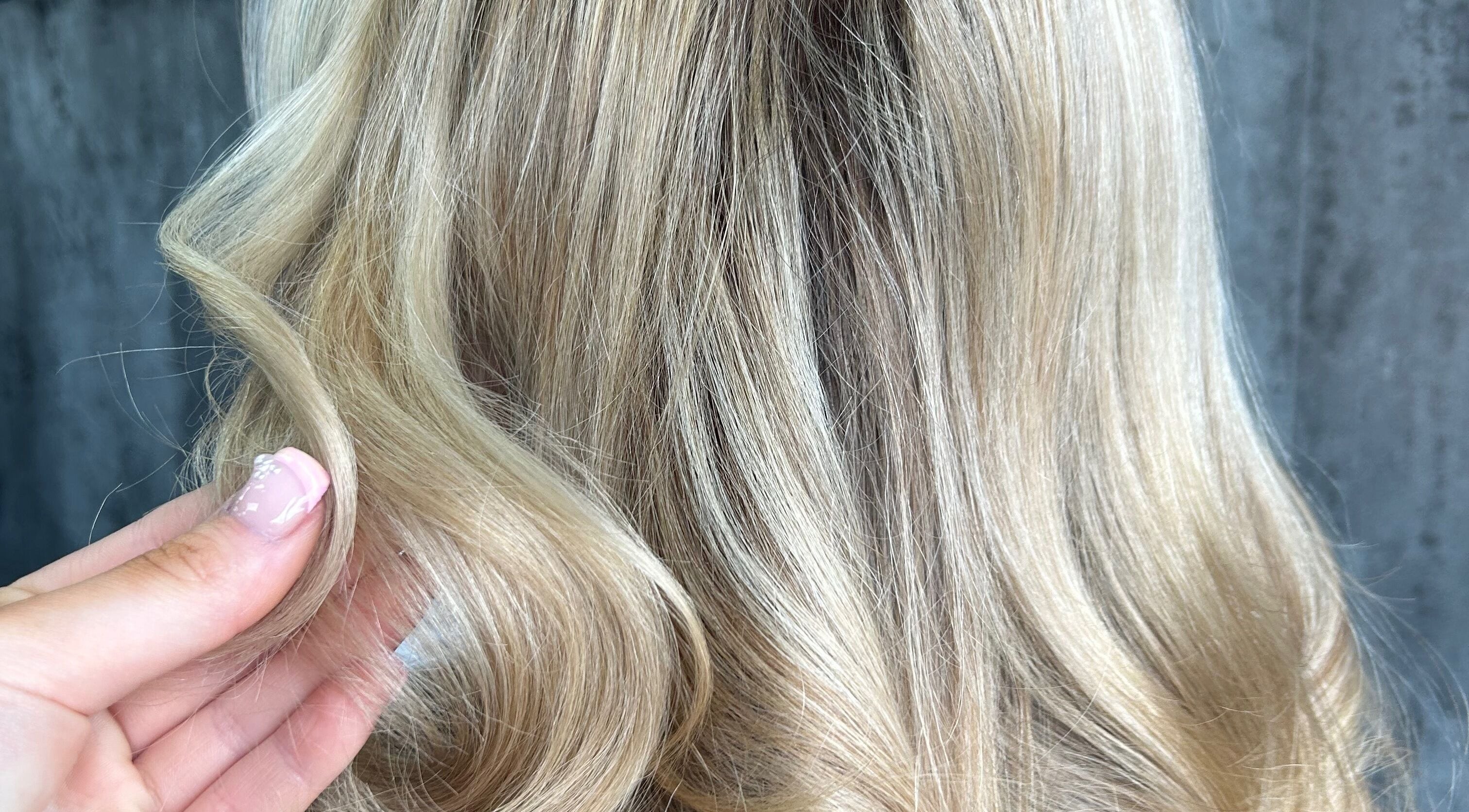 Blonde hair in soft curls at Emzhair, Alexandria, Scotland, GB.