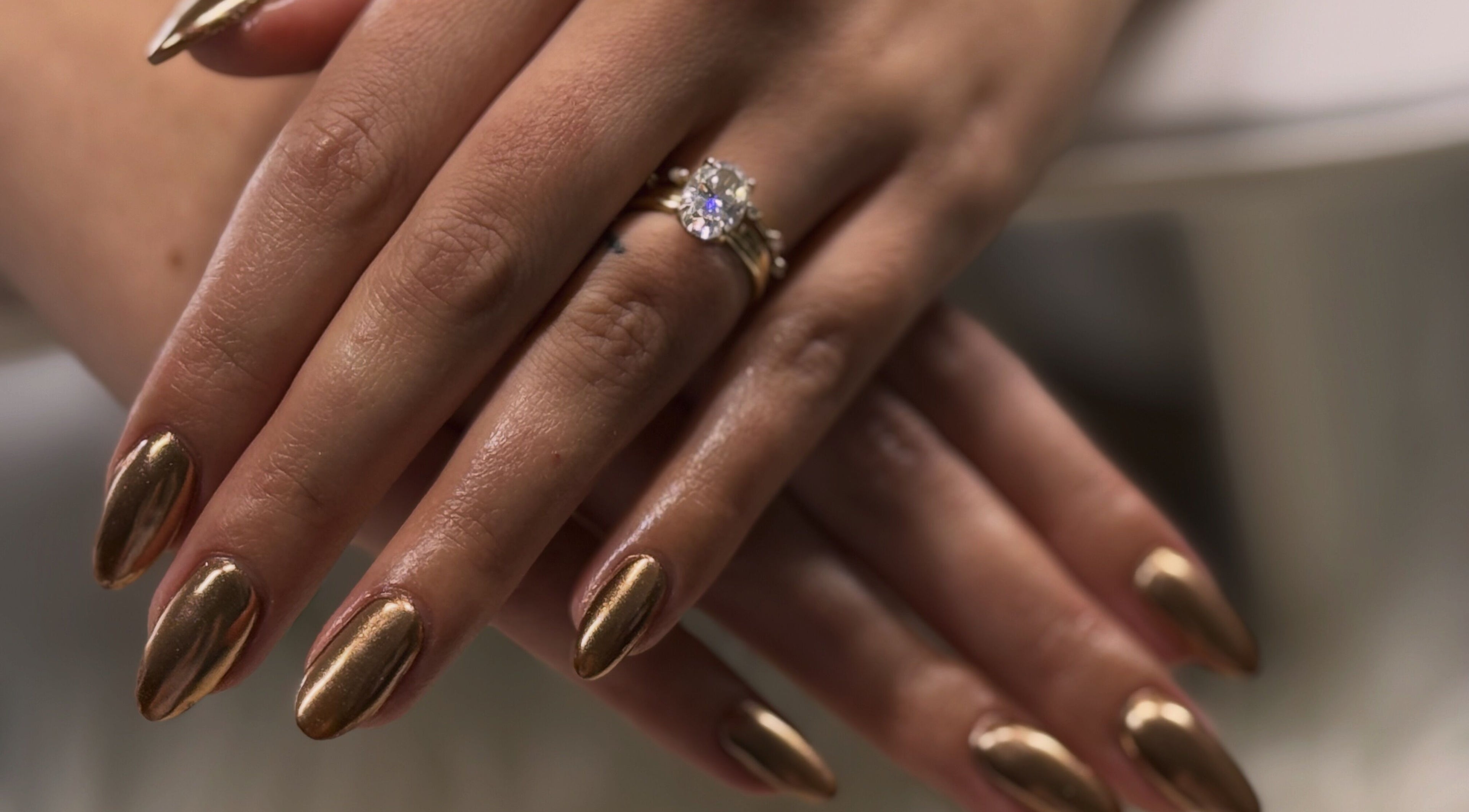 Glossy gold manicure at Nailed By Krisana in Spokane Valley, Washington, US showcases elegance and style.