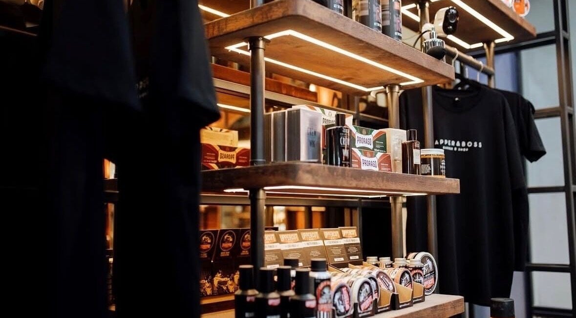 Grooming products at Dapper and Boss Eastquarter, Hurstville, New South Wales, AU, on wooden shelves.