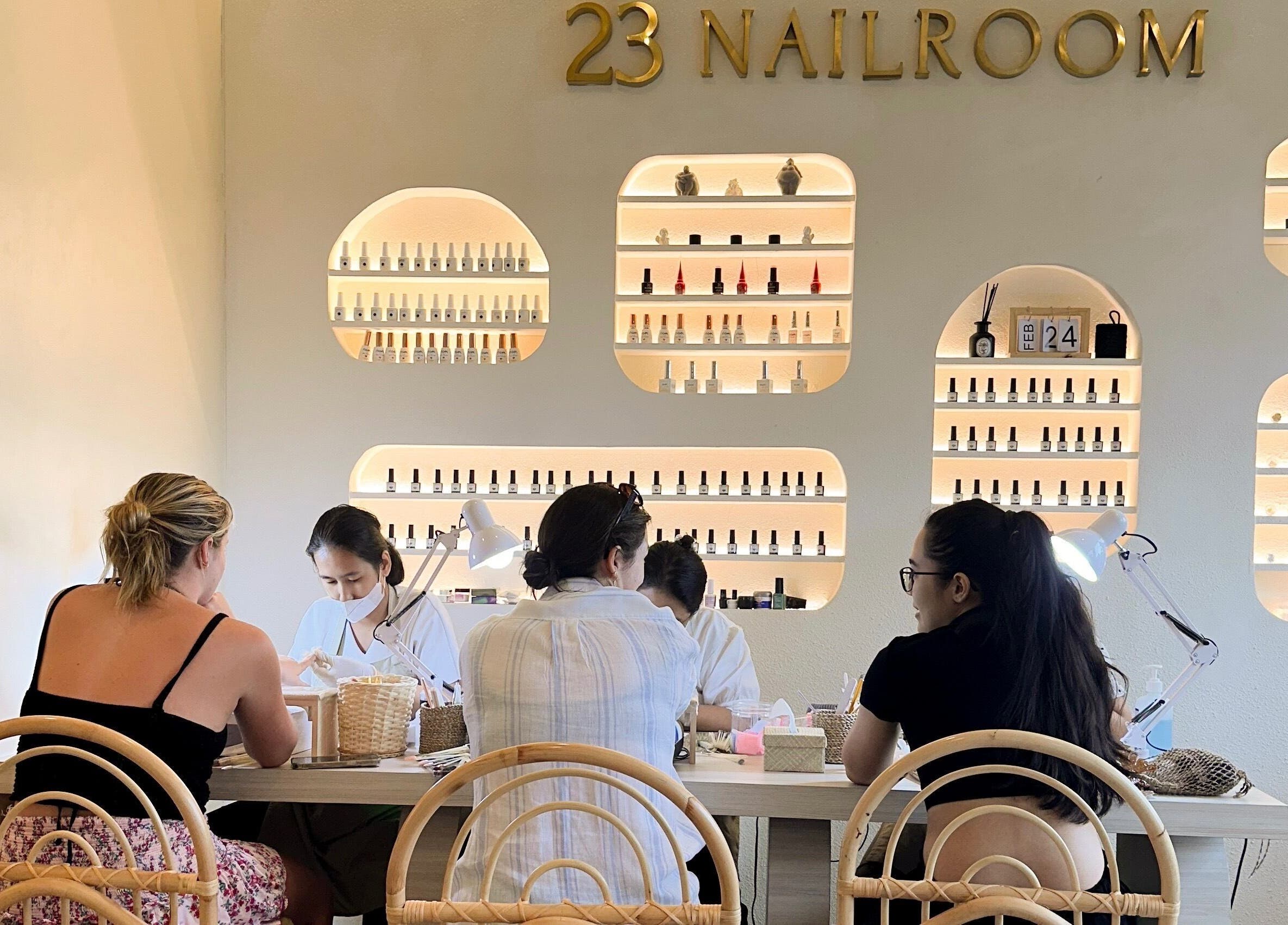 Stylish interior of 23 Nailroom in Bali, Bali, ID with clients receiving manicures.
