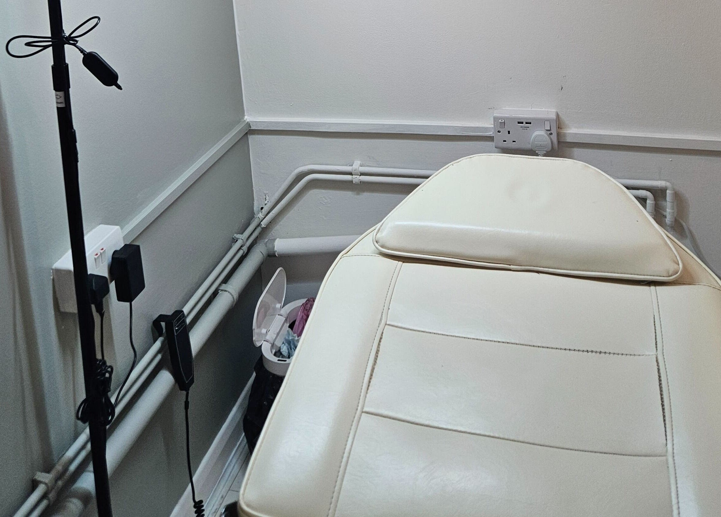 Relaxing treatment room at Pure Beauty Lounge, Hampton, England, GB featuring a comfortable spa bed.