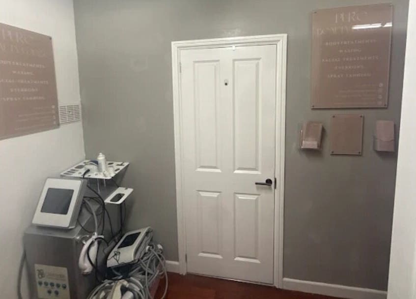 Treatment room at Pure Beauty Lounge, Hampton, England, GB, featuring advanced beauty equipment and calming decor.