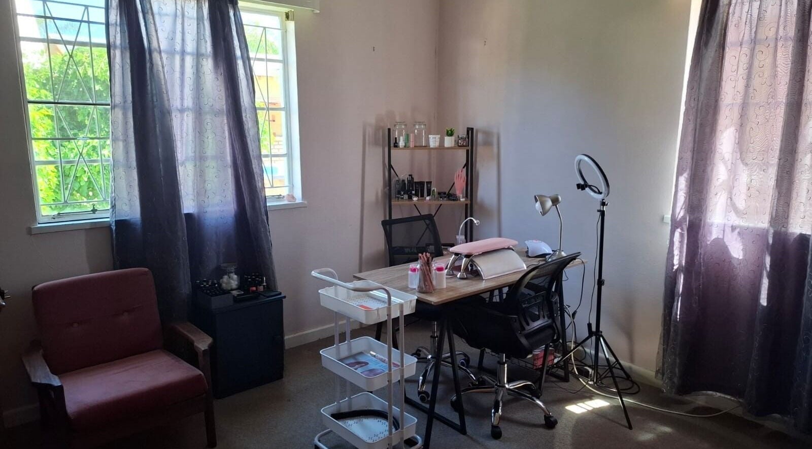 Warm nail studio interior at Nails By Emma, Upington, Northern Cape, ZA, with desk and manicure tools.