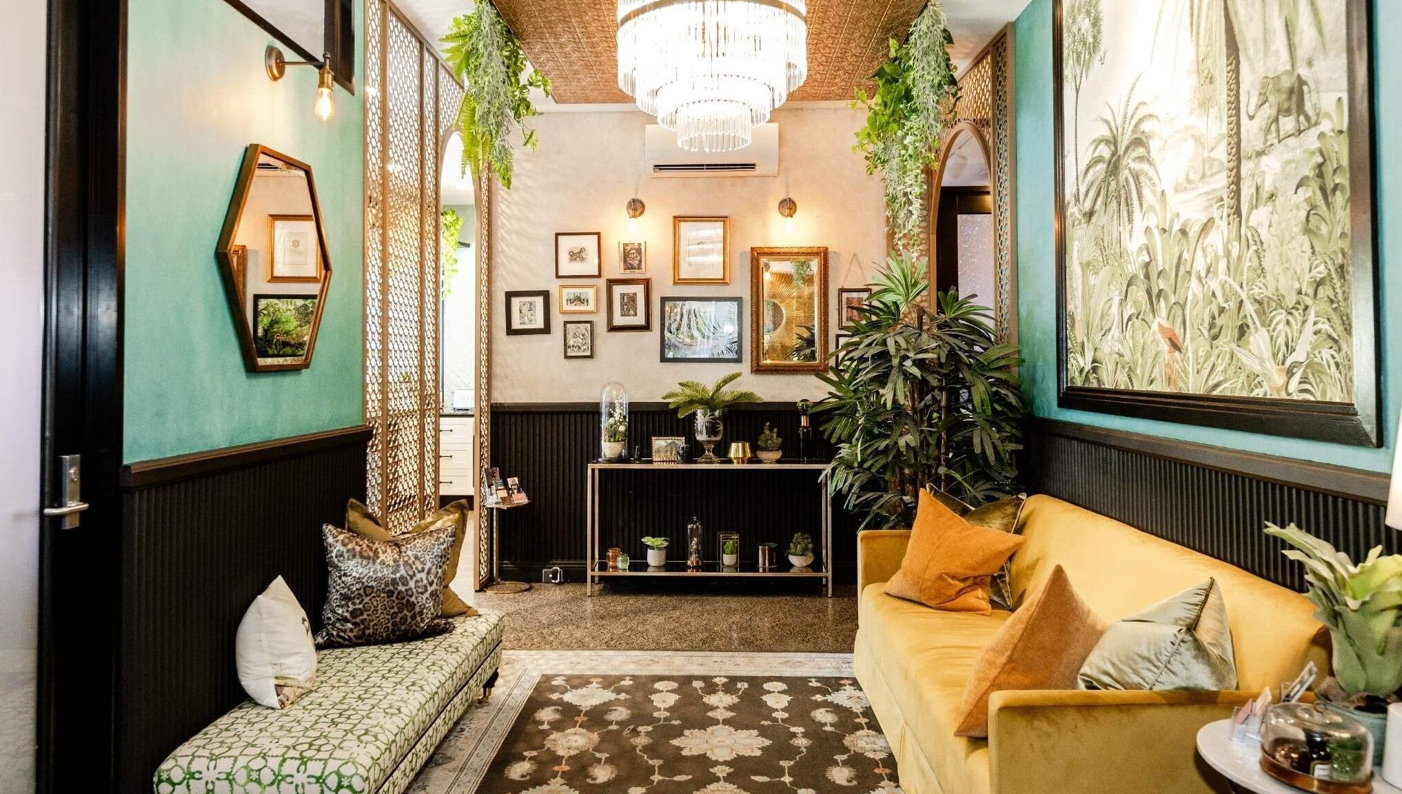 Inviting lounge area at Cry Baby Cosmetic Ink, Melbourne, Victoria, AU with chic decor and vibrant plants.