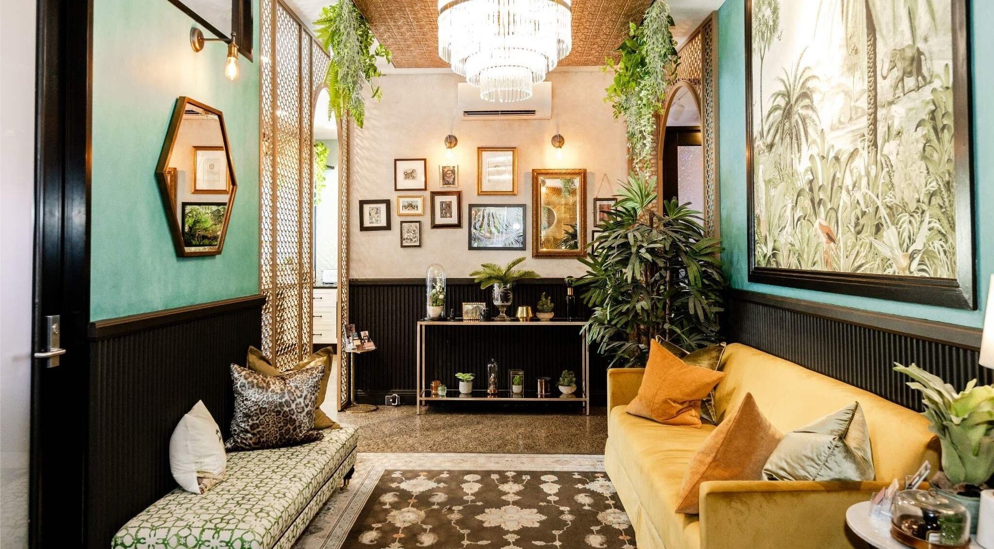 Inviting lounge area at Cry Baby Cosmetic Ink, Melbourne, Victoria, AU with chic decor and vibrant plants.