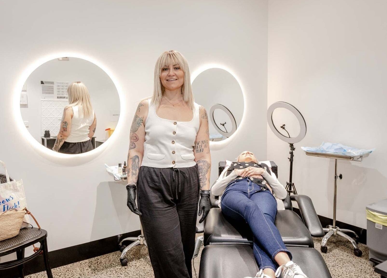 Expert artist at Cry Baby Cosmetic Ink, Melbourne, Victoria, AU, preparing a client in a modern studio.