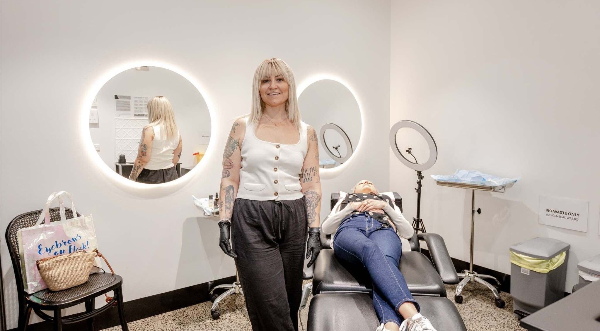 Expert artist at Cry Baby Cosmetic Ink, Melbourne, Victoria, AU, preparing a client in a modern studio.