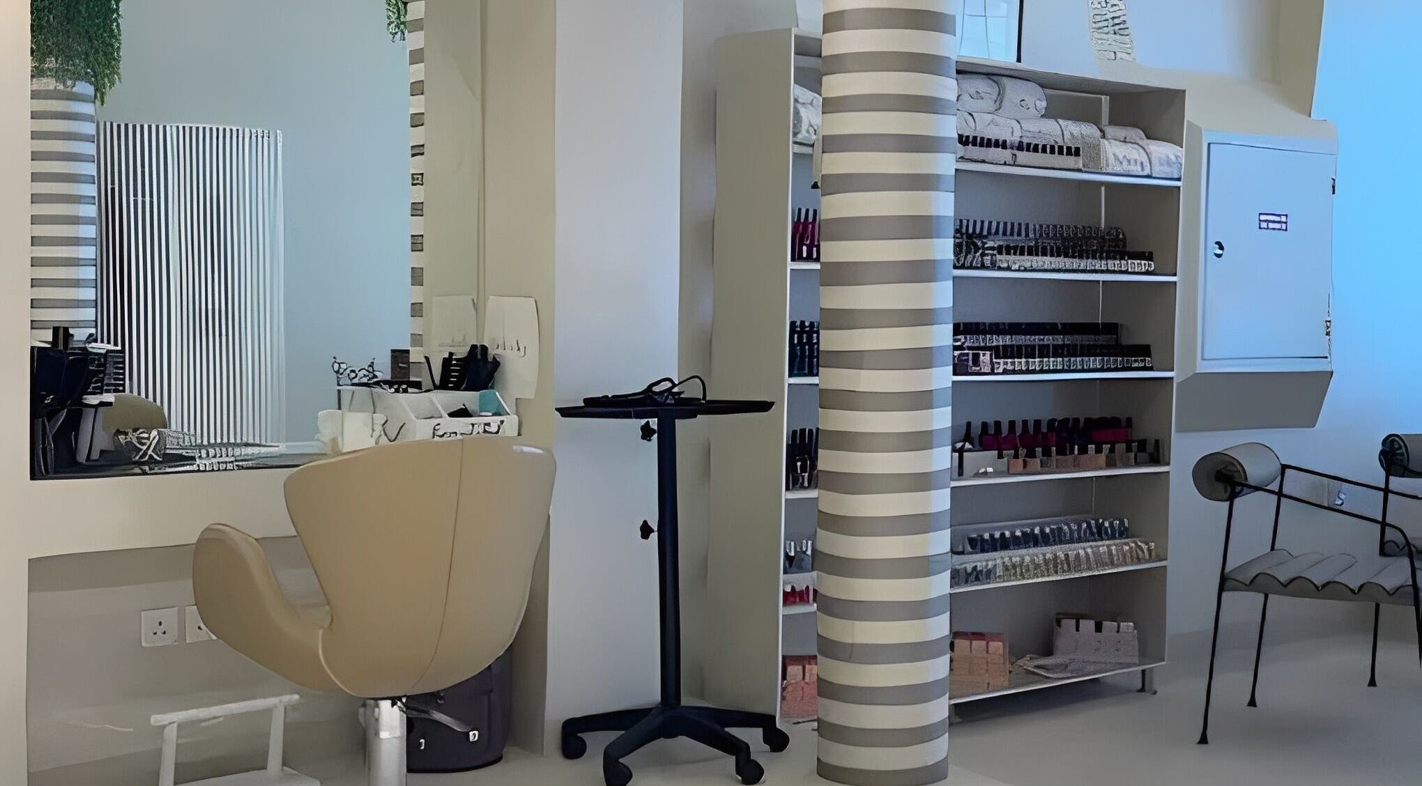 Cozy beauty station at betterfy, Riyadh, SA showcasing salon chair and organized products shelf.