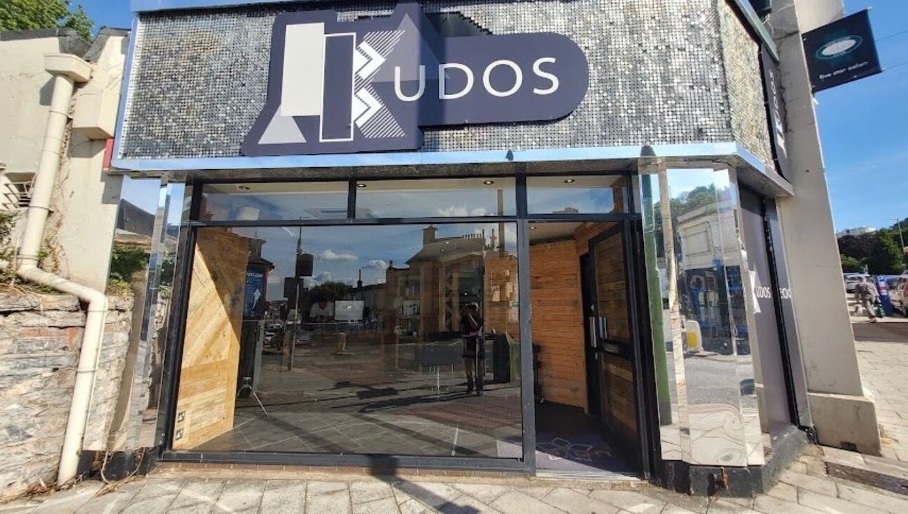 Modern facade of The Ink Fairy in Torquay, England, GB showcasing glass and wood elements.