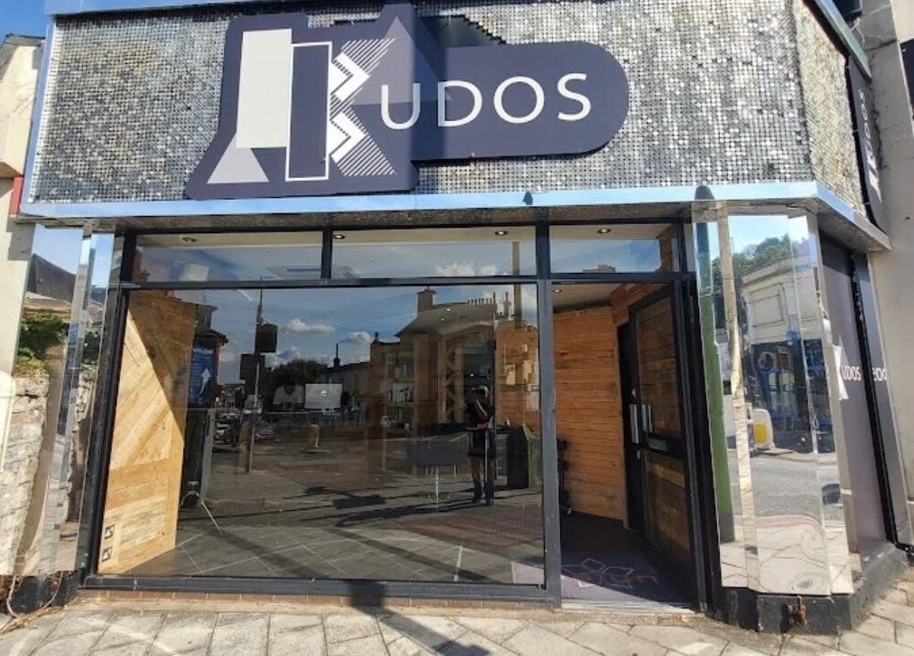 Modern facade of The Ink Fairy in Torquay, England, GB showcasing glass and wood elements.