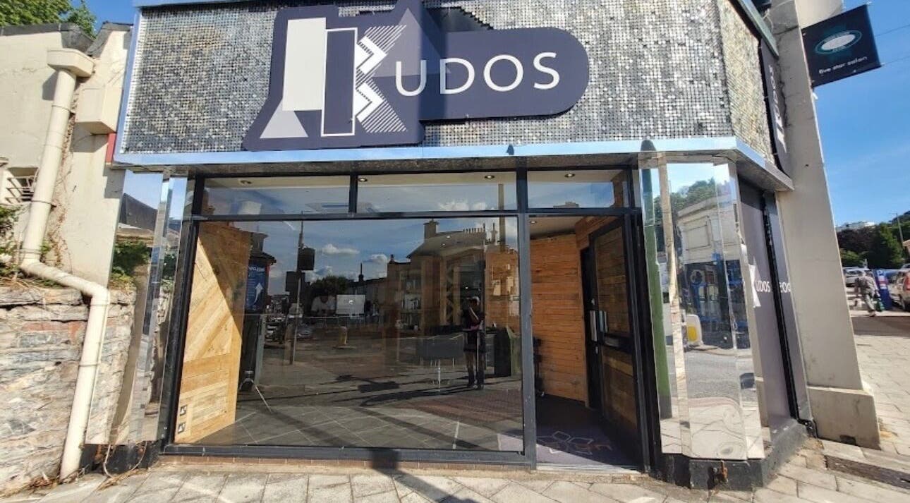 Modern facade of The Ink Fairy in Torquay, England, GB showcasing glass and wood elements.