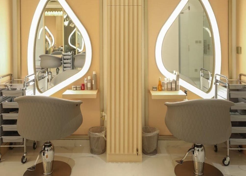 Modern salon interior at Alma Beauty Center in Riyadh, Riyadh Province, SA, showcasing elegant styling stations.