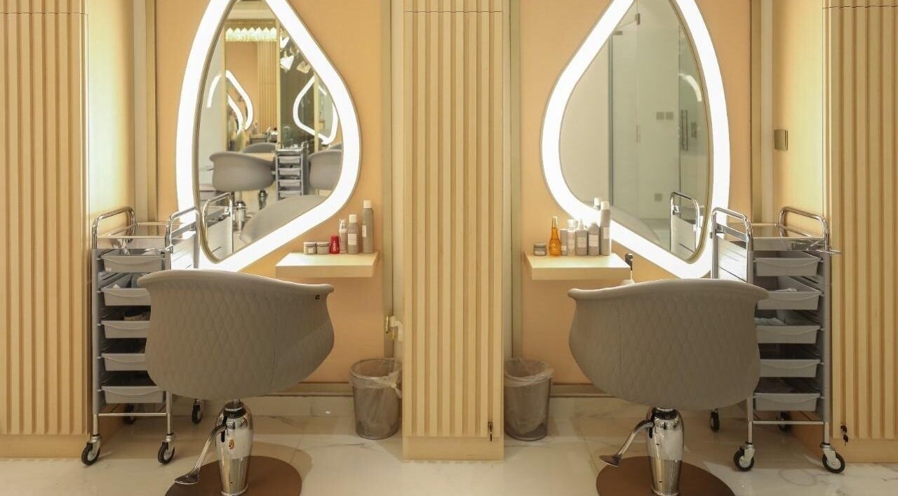 Modern styling stations at Alma Beauty Center in Riyadh, Riyadh Province, SA with chic chairs and mirrors.