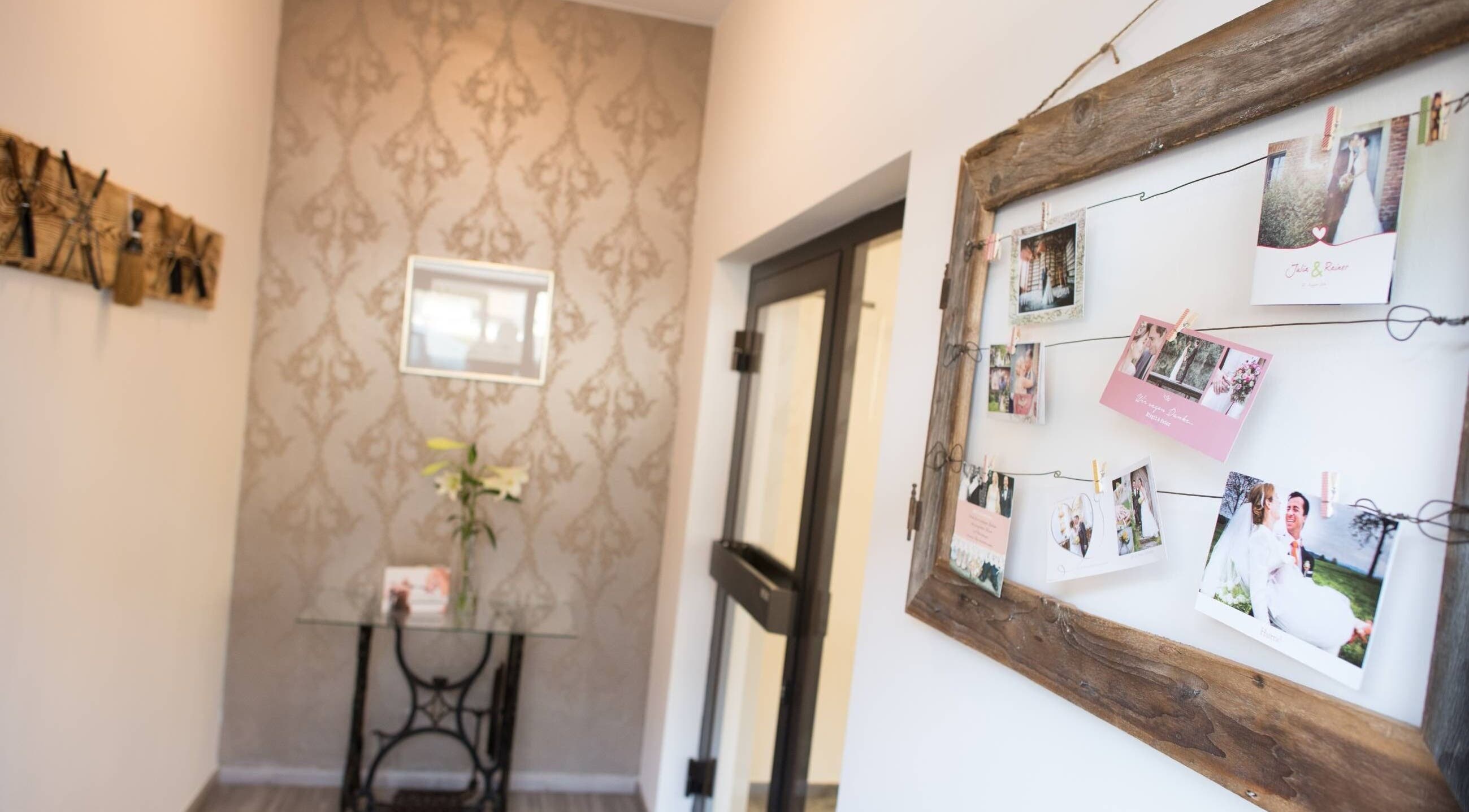 Warm entryway with floral decor and photo display at Aurion Labs, Wien, Wien, AT.