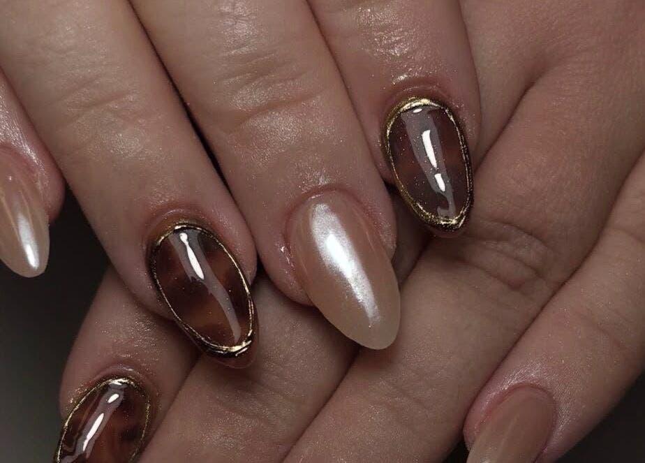 Stylish nail art at Hollie’s Nails in Radcliffe, England, GB showcasing glossy and metallic finishes.
