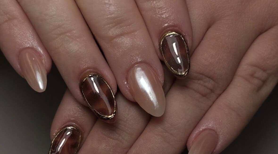 Stylish nail art at Hollie’s Nails in Radcliffe, England, GB showcasing glossy and metallic finishes.