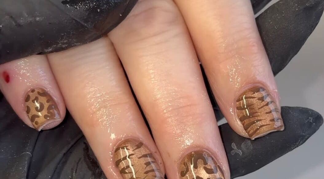 Leopard print nail art by Hollie's Nails in Radcliffe, England, GB. Stylish brown designs on manicured nails.