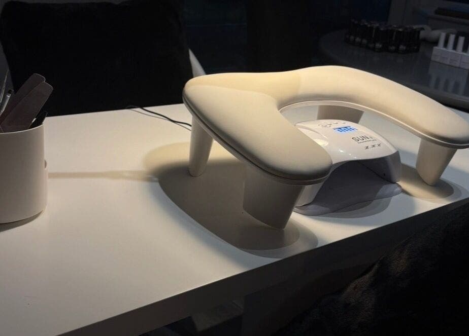 Nail station setup at Hollie’s nails in Radcliffe, England, GB featuring tools and a UV lamp.