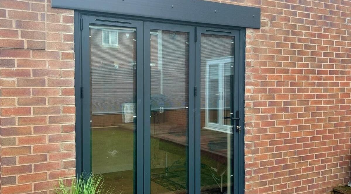 Modern glass door entrance at THRIVE Massage Therapy - QUORN, Quorn, England, GB, showcasing outdoor reflection.