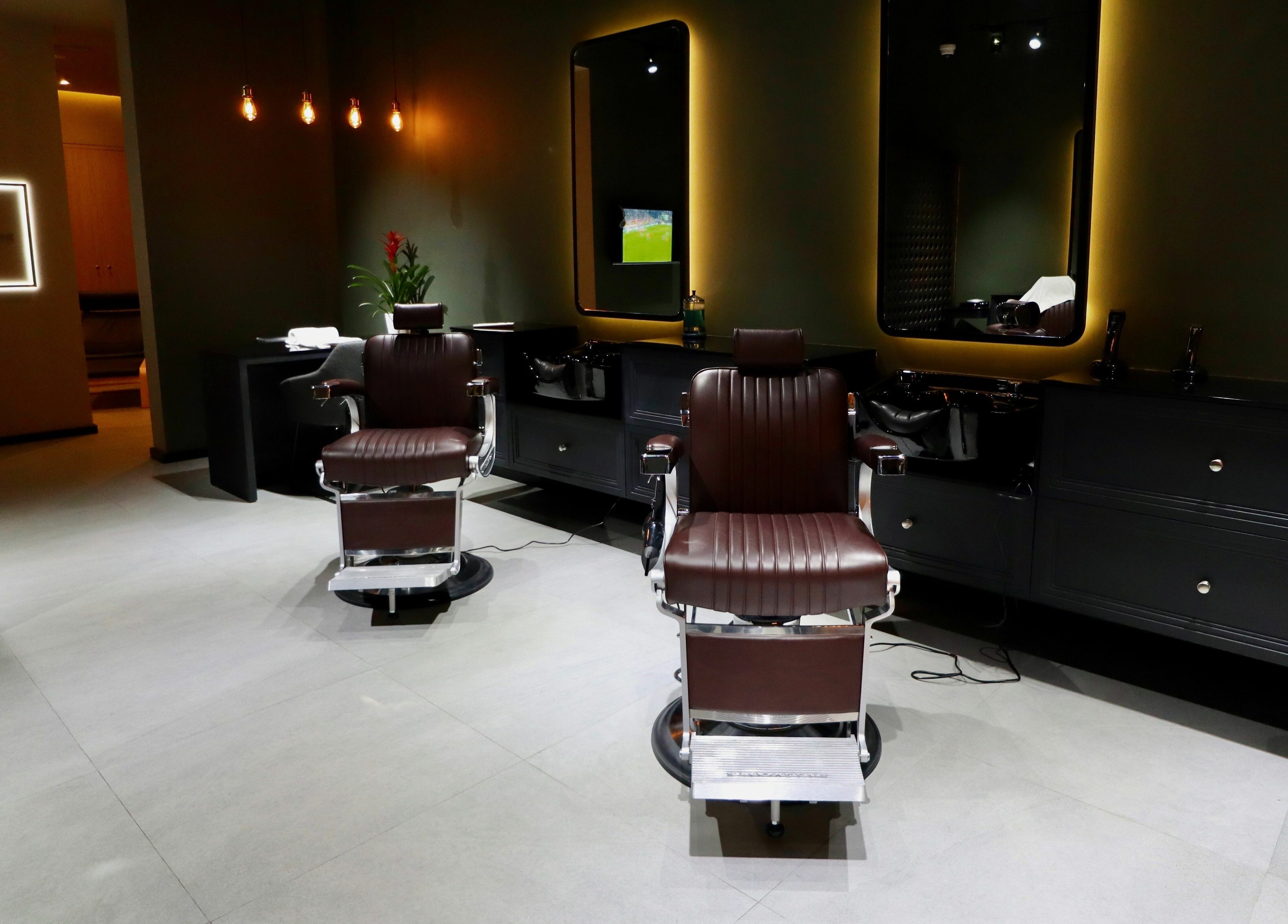 Sleek barber chairs at Cape & Fade in Dubai, AE, showcasing a modern and luxurious salon interior.