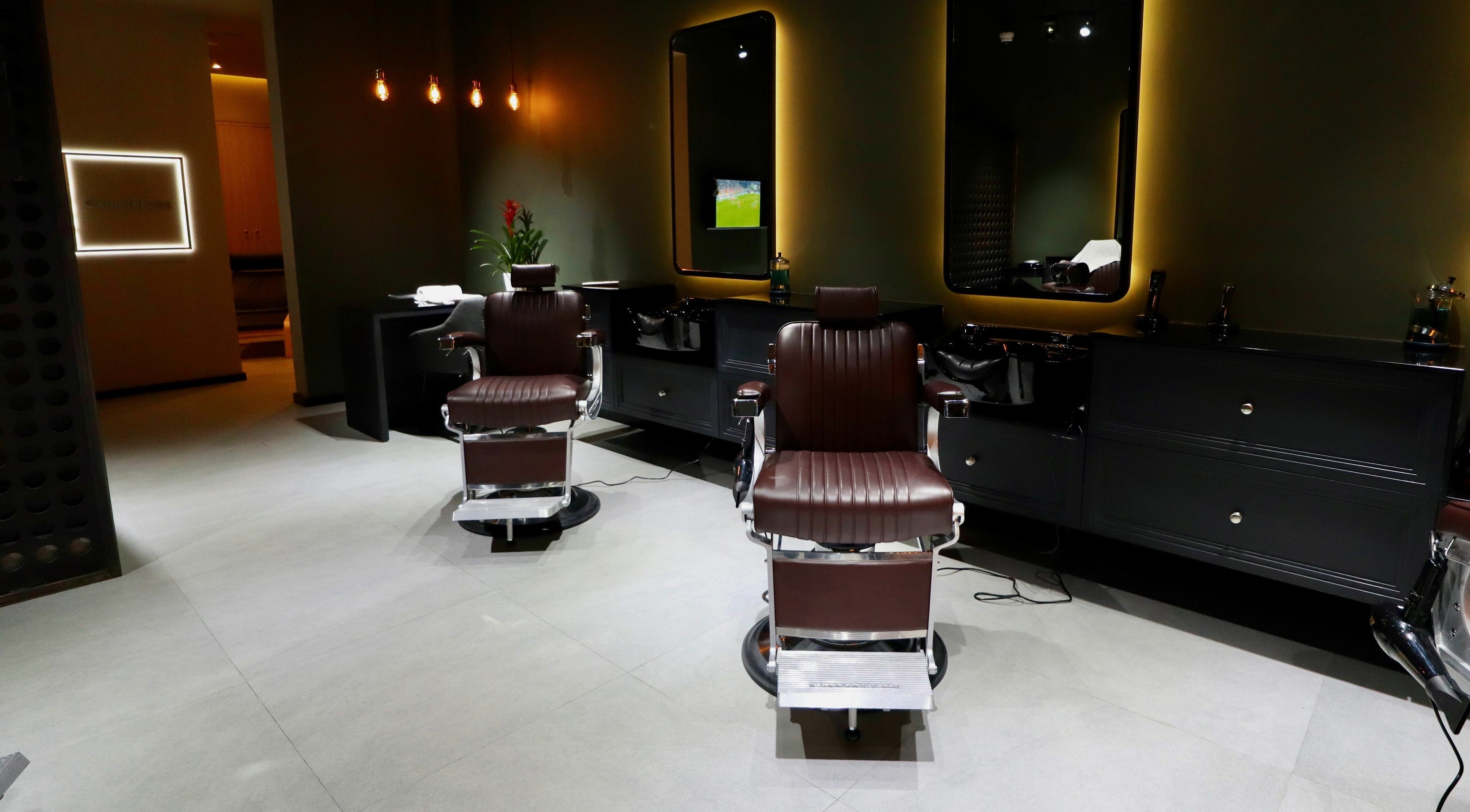 Sleek barber chairs at Cape & Fade in Dubai, AE, showcasing a modern and luxurious salon interior.