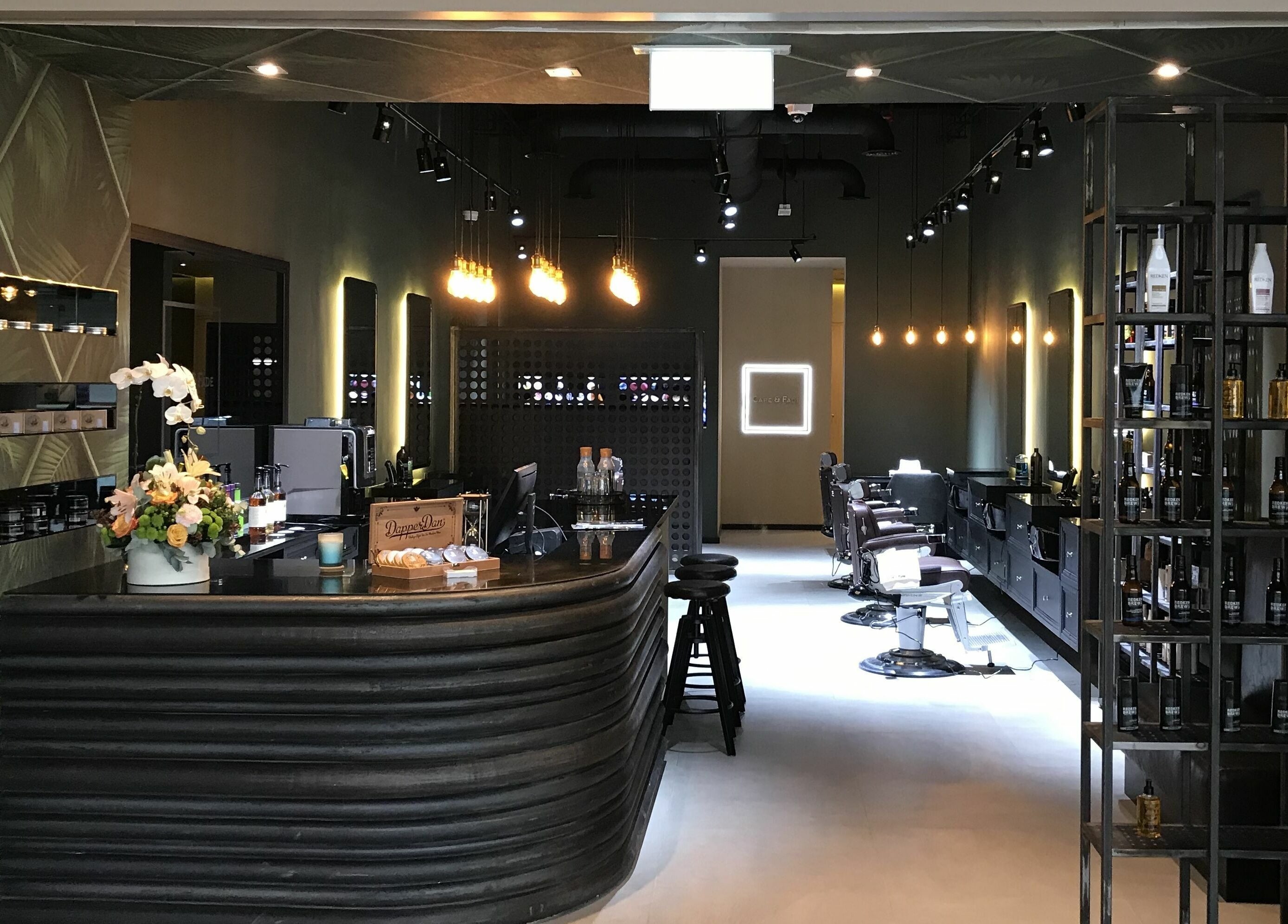 Sophisticated interior of Cape & Fade in Dubai, AE, featuring stylish decor and barber chairs.