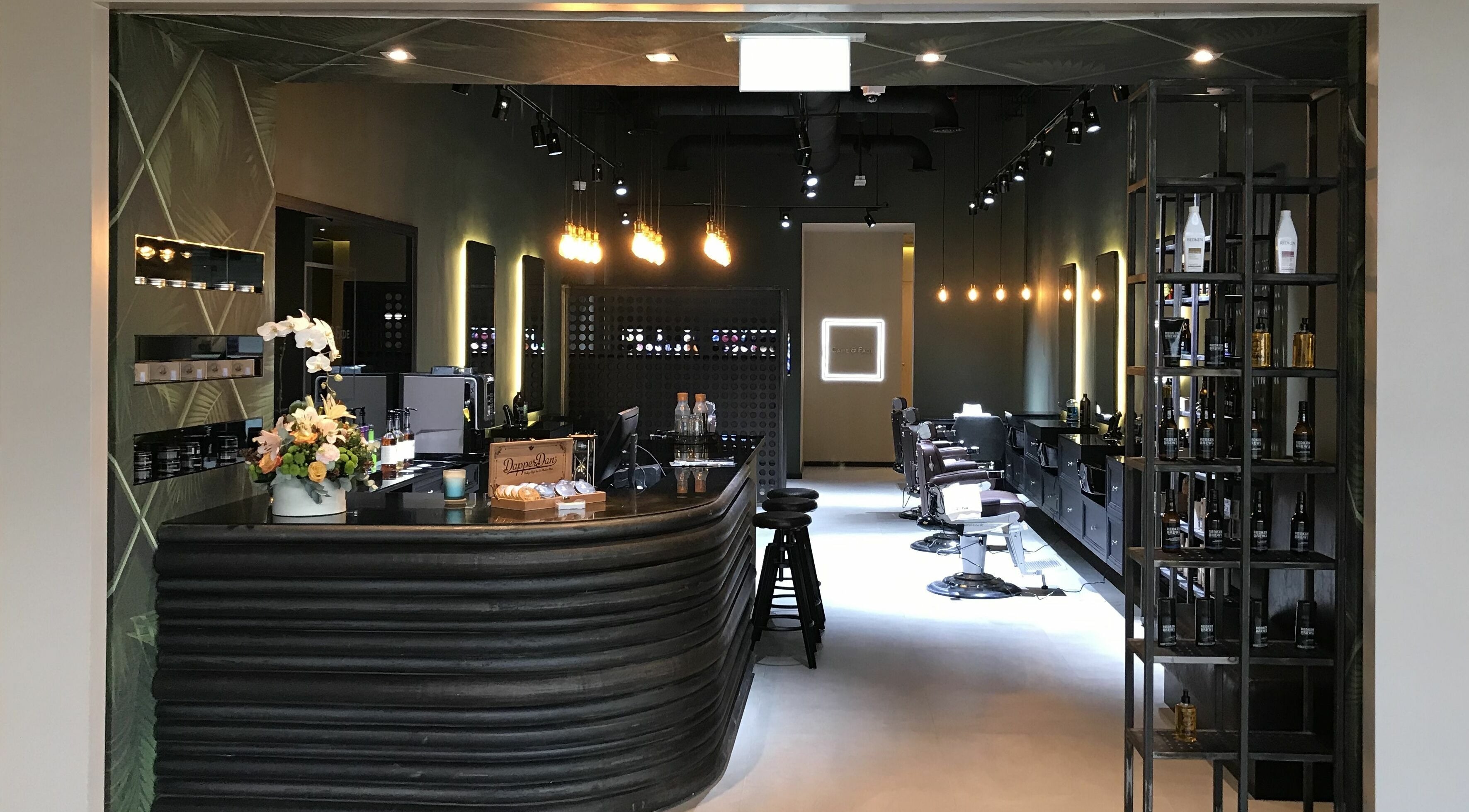 Sophisticated interior of Cape & Fade in Dubai, AE, featuring stylish decor and barber chairs.