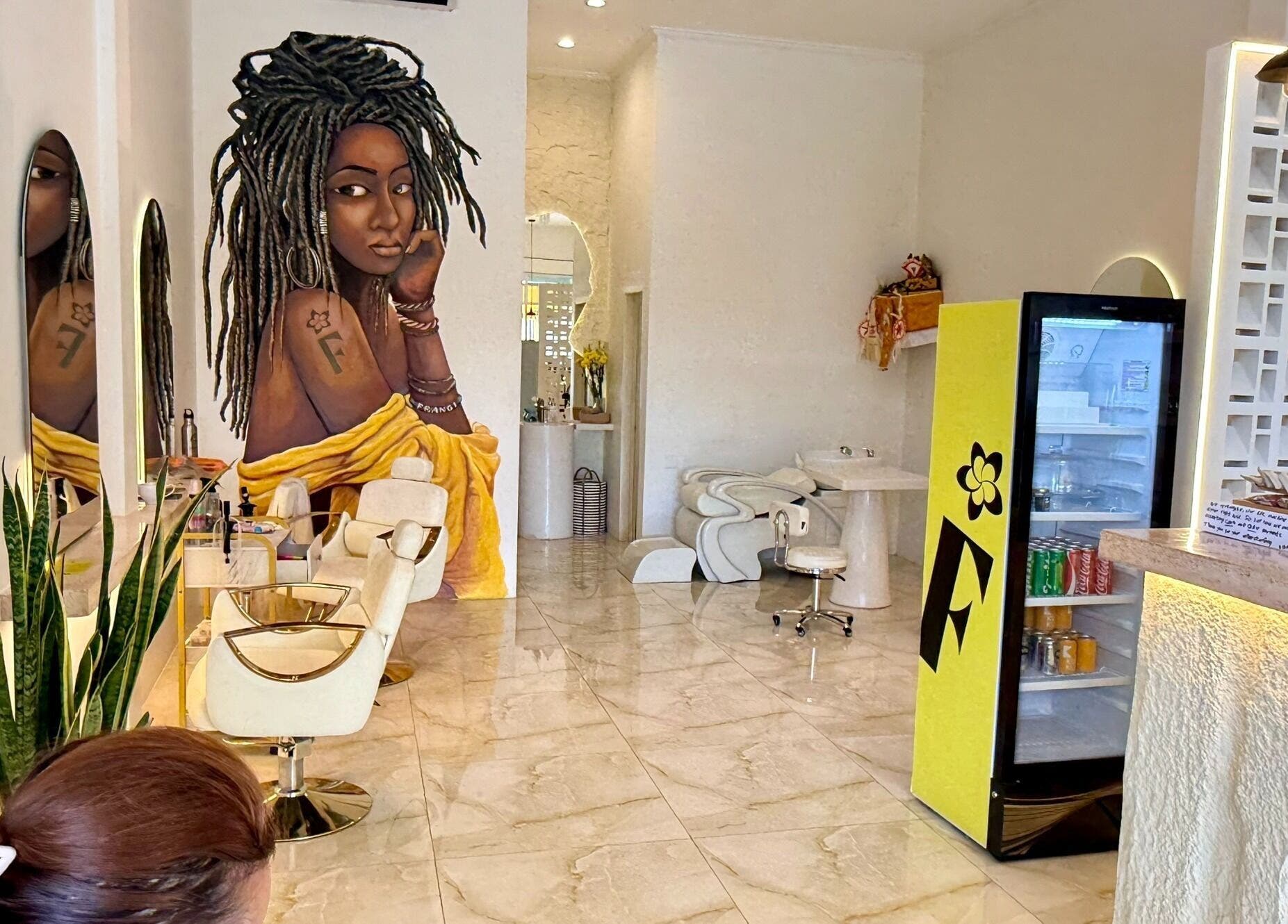 Modern interior of Frangi Braids Salon in Bali, Bali, ID, featuring stylish decor and vibrant mural art.