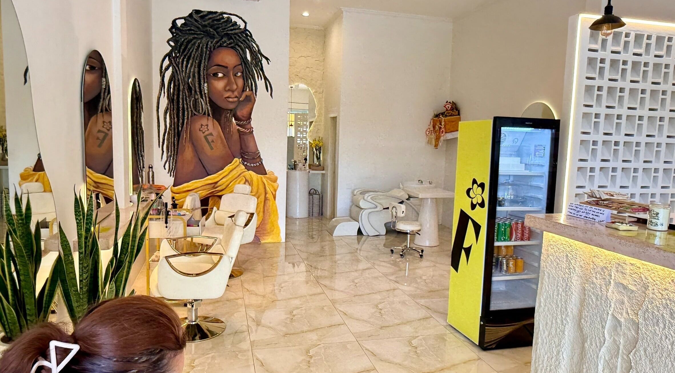 Modern interior of Frangi Braids Salon in Bali, Bali, ID, featuring stylish decor and vibrant mural art.