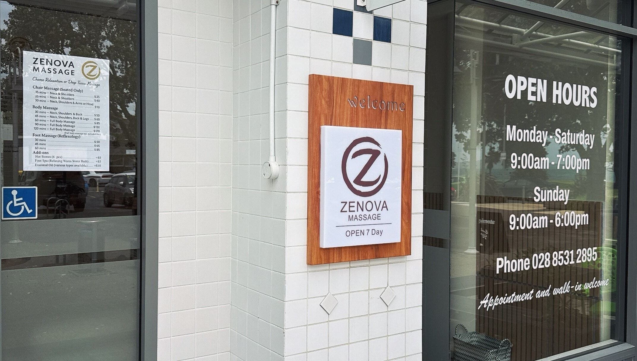 Entrance of Zenova Massage in Auckland, Auckland, NZ, showcasing hours and accessibility signage.