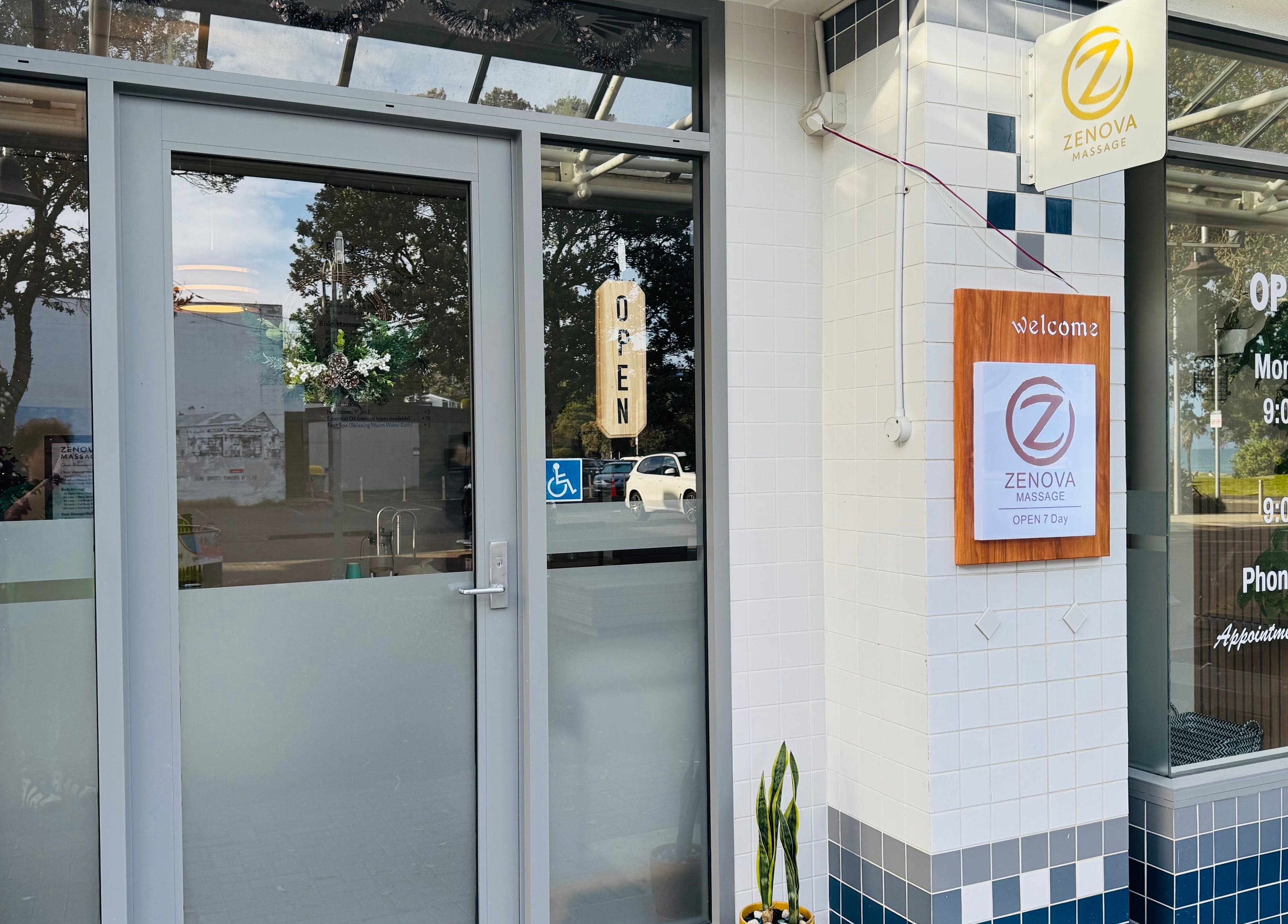 Front entrance of Zenova Massage in Auckland, NZ, showcasing signage and open hours.