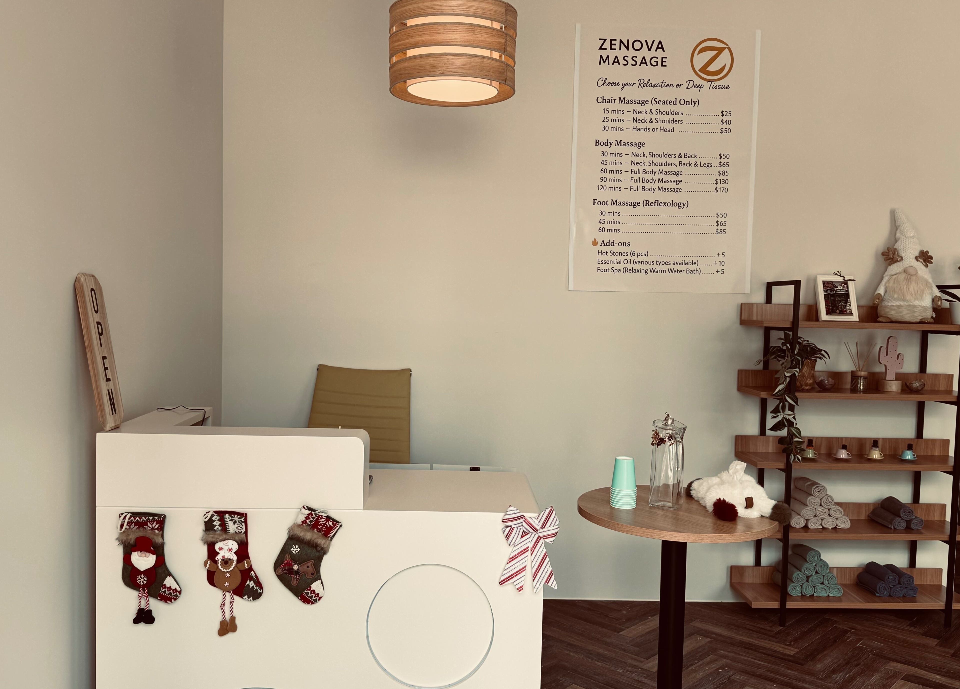 Warm, inviting reception at Zenova Massage in Auckland, NZ with decor and menu displayed.