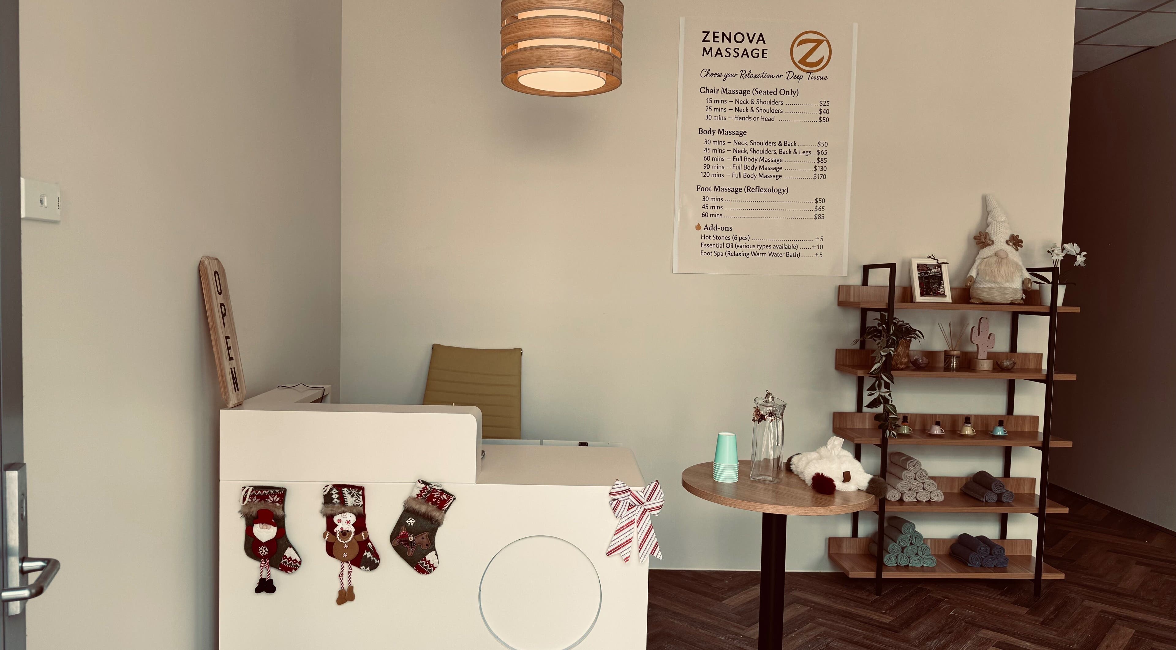 Warm, inviting reception at Zenova Massage in Auckland, NZ with decor and menu displayed.