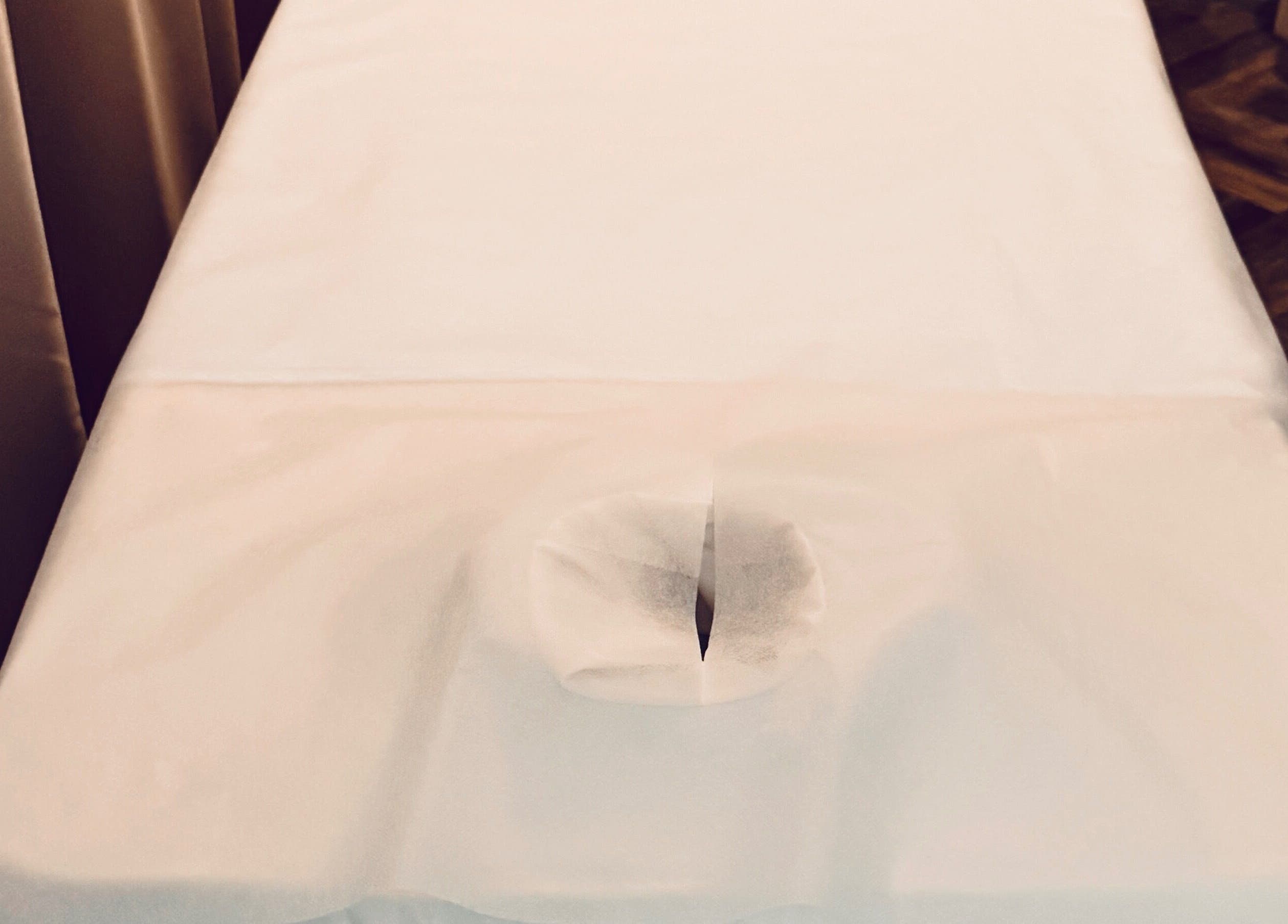 Massage table at Zenova Massage, Auckland, NZ prepared for relaxation session.