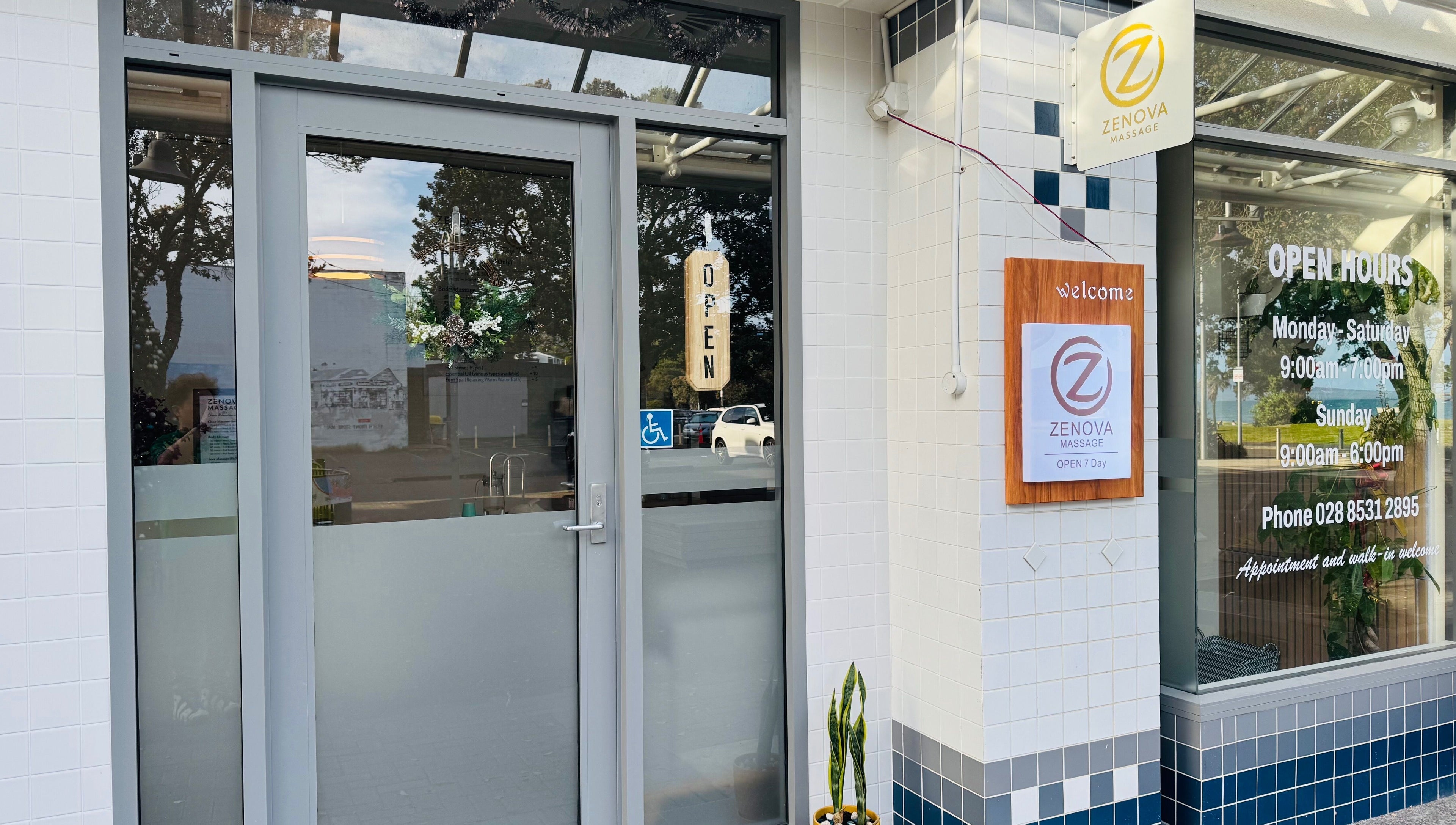 Entrance of Zenova Massage, located at Auckland, Auckland, NZ, with welcome sign and opening hours.