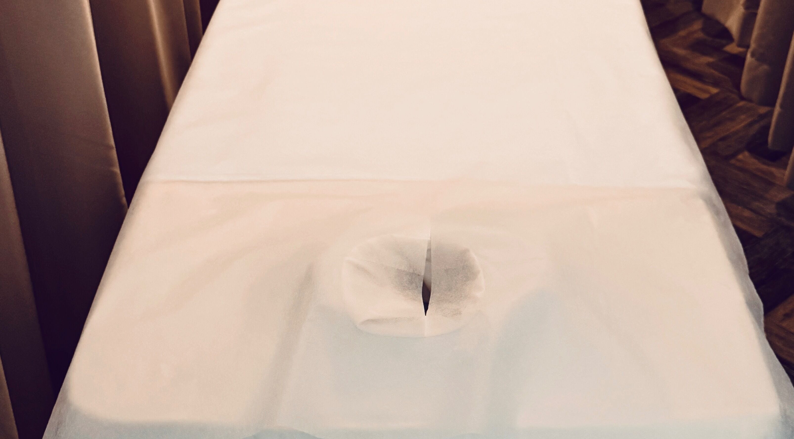 Massage table at Zenova Massage in Auckland, NZ, offering relaxation and comfort.