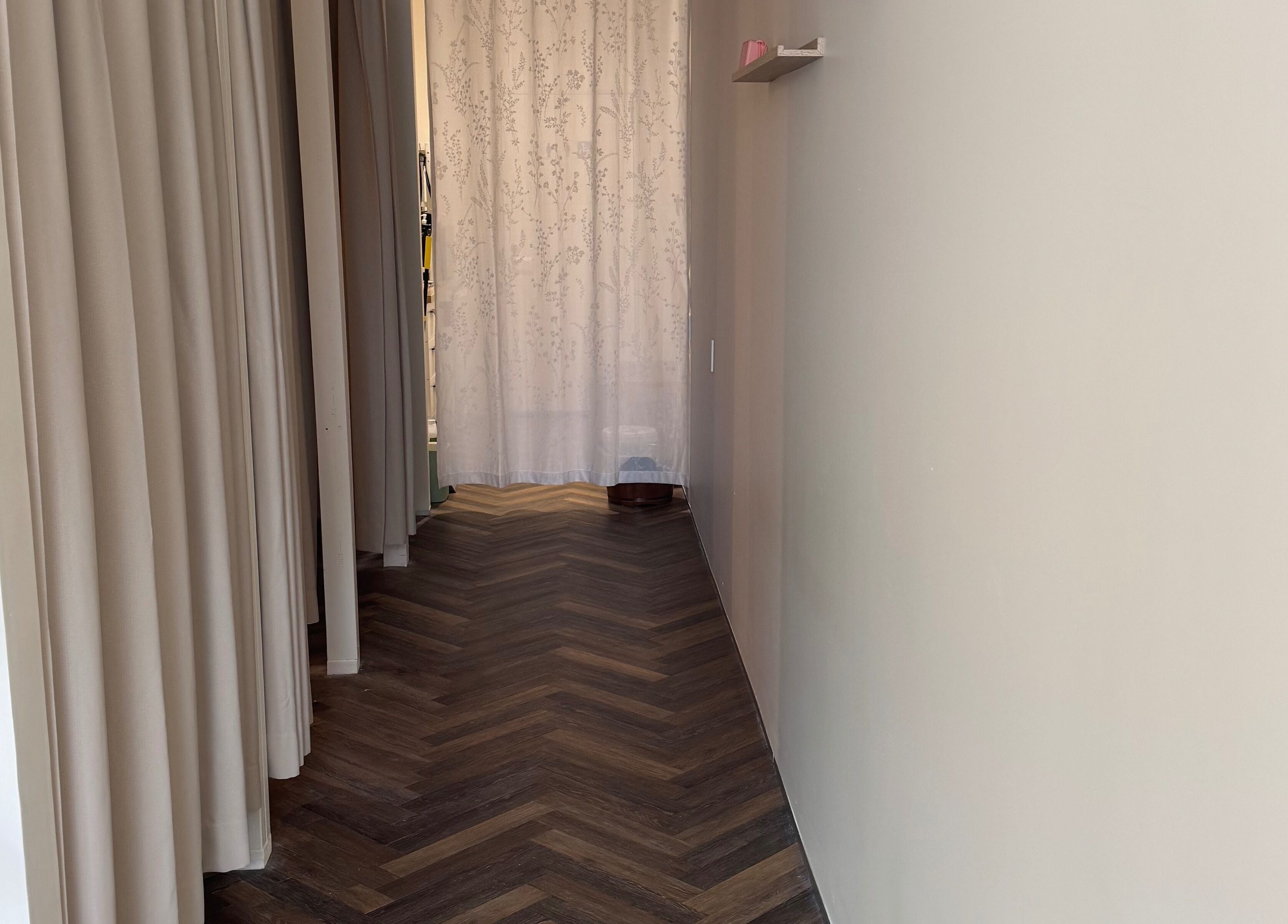 Serene corridor at Zenova Massage in Auckland, NZ with calming decor and soft lighting.