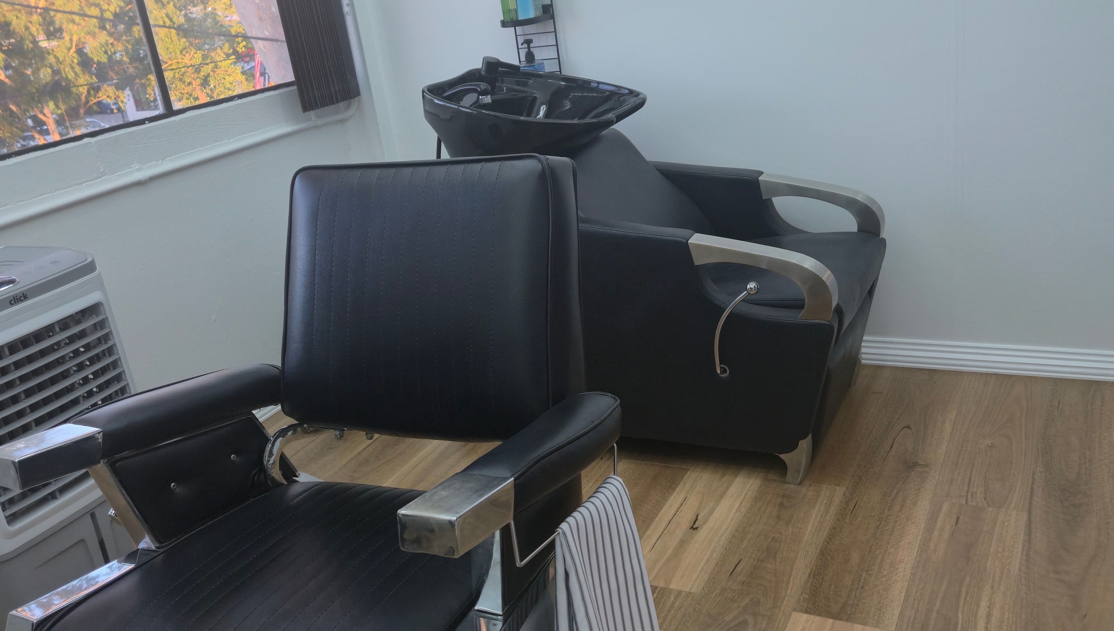 Modern barber chair at Midnight Barber Sydney in Bankstown, New South Wales, AU amidst a stylish setup.